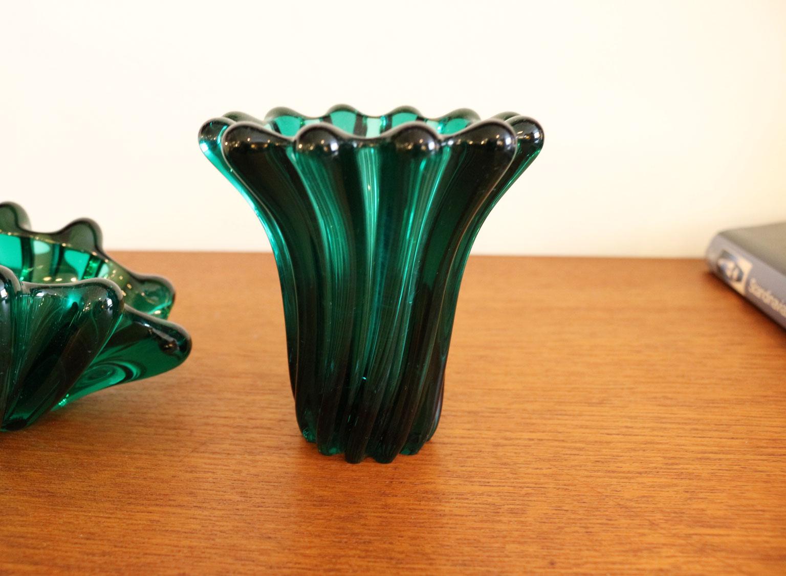 Consider this Scandinavian vase and dish set the next addition to your blossoming midcentury decorative glass collection. The modernist design of each piece has a slight organic quality thanks to the gestural form and vibrant green color.
Measures: