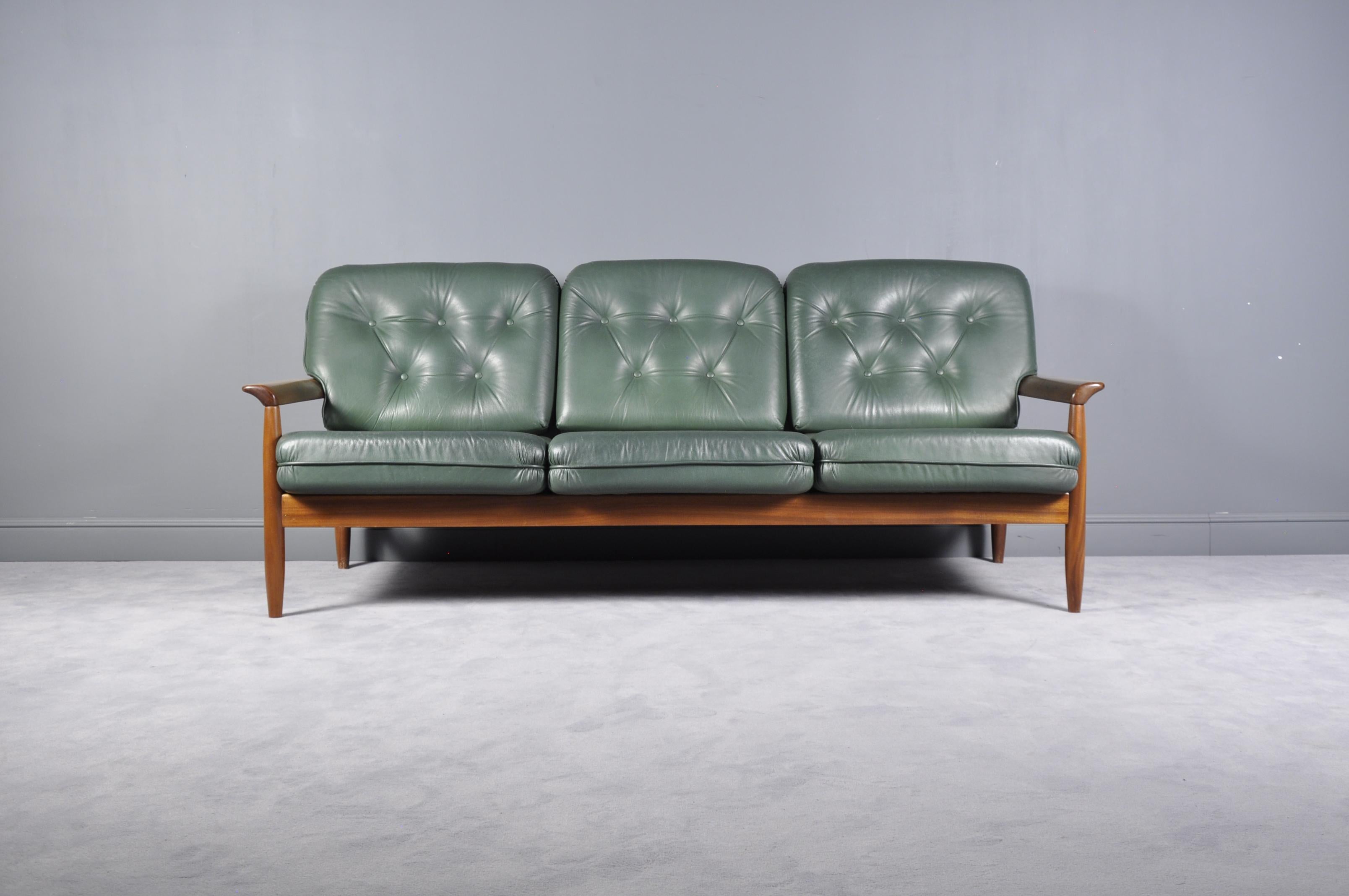 Mid-Century Modern soft green leather Scandinavian sofa set, produced in the 1960s in style of the Danish designer Arne Norell. The sofa set features an teak wooden base and green leather upholstery which is in an overall good condition. The
