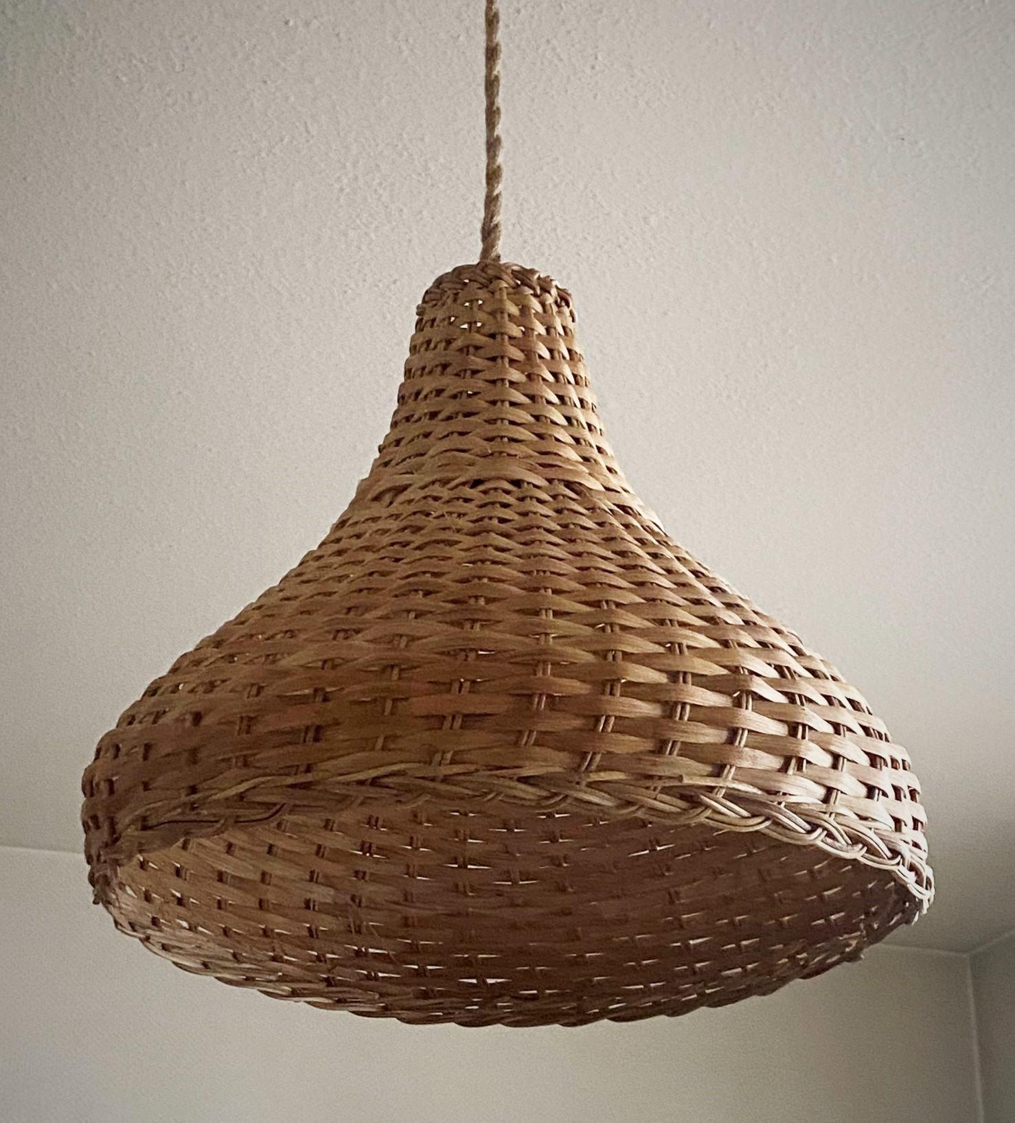 Vintage Scandinavian handcrafted natural woven rattan pendant light in basket shape from 1960s.
It takes one Edison E27 large sized bulb. 
Overall Hight as pictured: 36