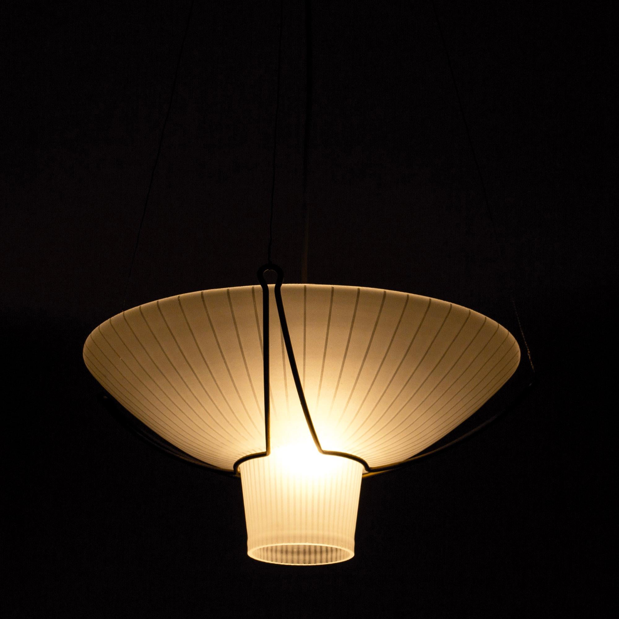 Elegant ceiling lamp by Hans Bergström, with a glass shade suspended in a cool brass frame. Looks great glowing in the dark.

Hans Bergström was the owner and creative director of the lighting firm Ateljé Lyktan, which he founded in Åhus in the