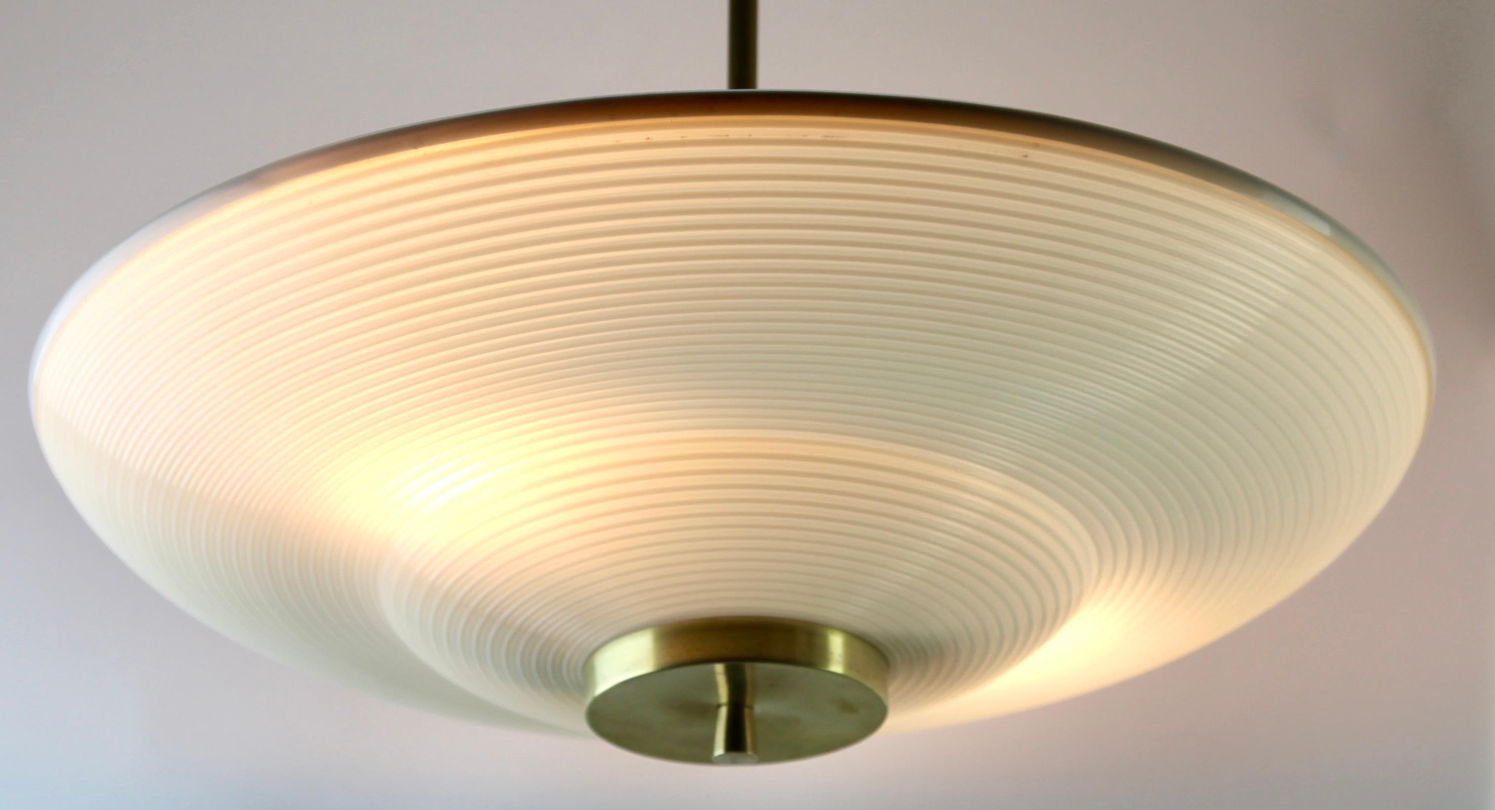 Hanging pendant light from the late 1960s designed in the Scandinavian style and Acrylic optical Shade 
Its Classic modernist form and simplicity in design, make it an iconic example of midcentury home lighting.
Size shade: diameter 16.9 -inch