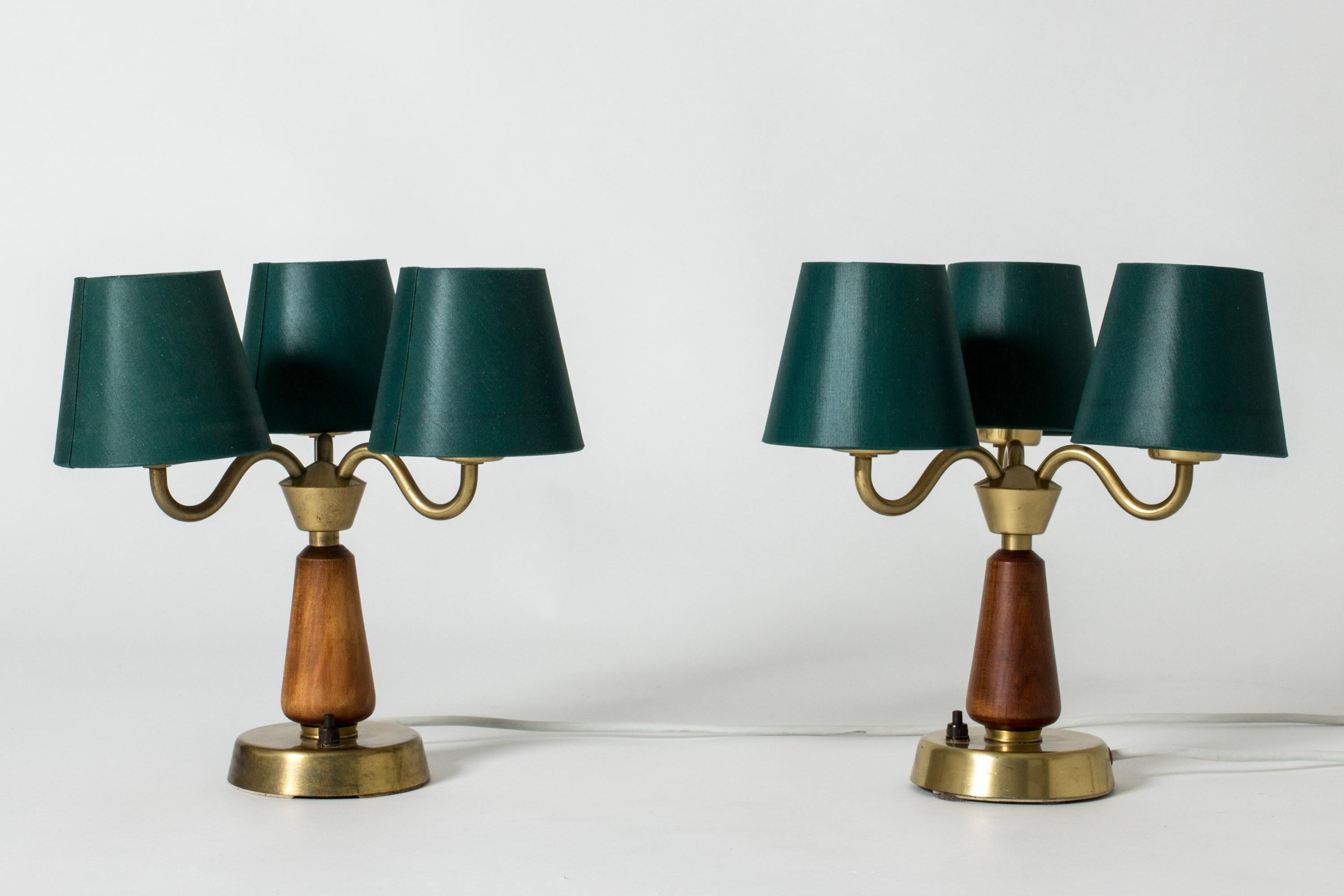 Pair of brass and mahogany table lamps from ASEA, in a compact design with three shades on each. Lovely curved forms.