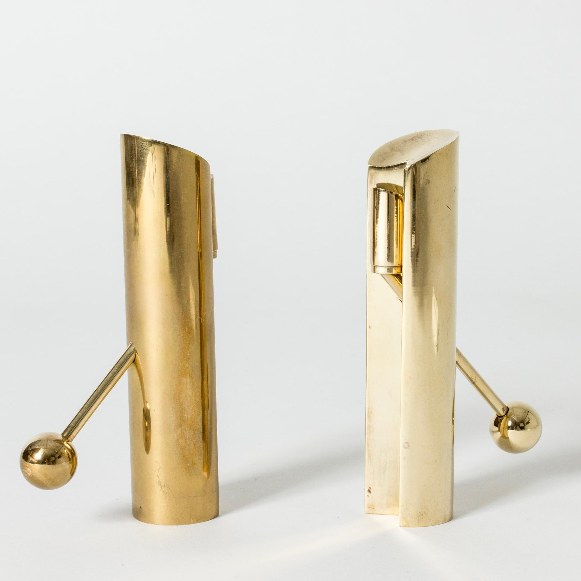 Pair of heavy, solid brass “Variabel” candlesticks by Pierre Forssell. The diagonal arms slide through the bases to fasten the candle. The design springs from Forssell’s idea that the whole candle should be visible as it burns.

Pierre Forssell was