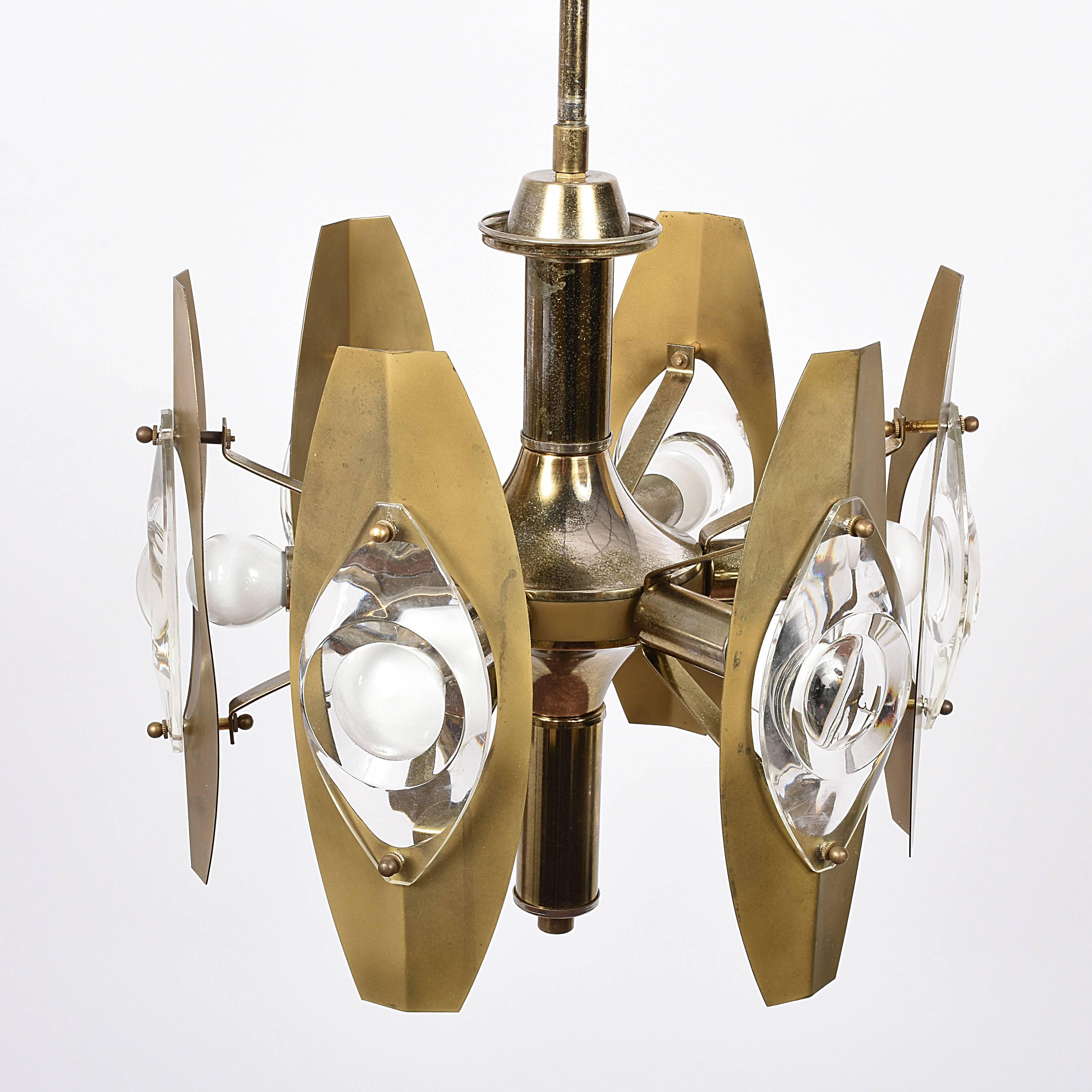 Amazing midcentury glass and polished gilt brass chandelier. This item was designed in Italy during 1960s by Gaetano Sciolari.

This chandelier has six-arms which hold large glass lenses and sockets for small base bulbs or LEDs with maximum 40W