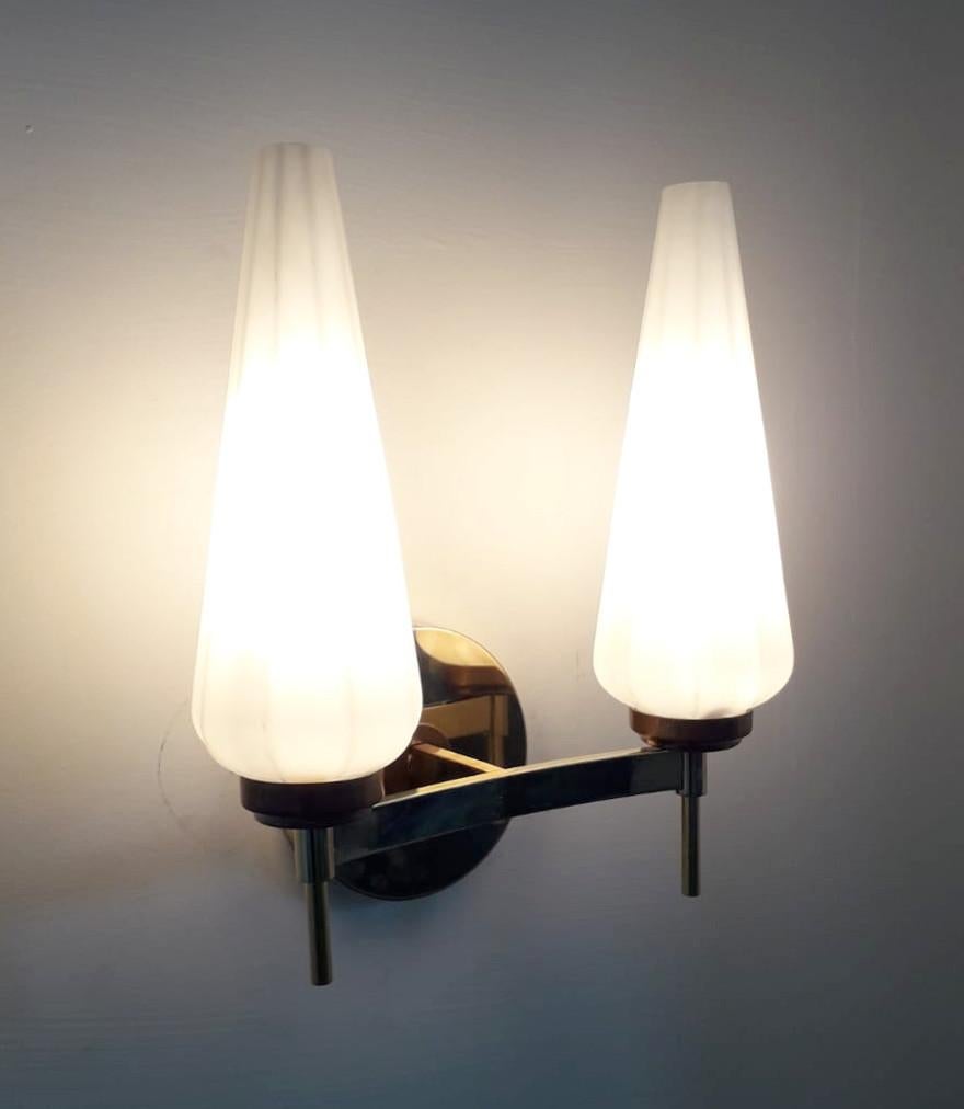 Vintage Italian wall lights with opaline cone shaped glass diffusers mounted on brass frames, in the style of Stilnovo / Made in Italy, circa 1950s
Measures: height 11.5 inches, width 10.5 inches, depth 5.5 inches
2 lights / E12 or E14 type / max