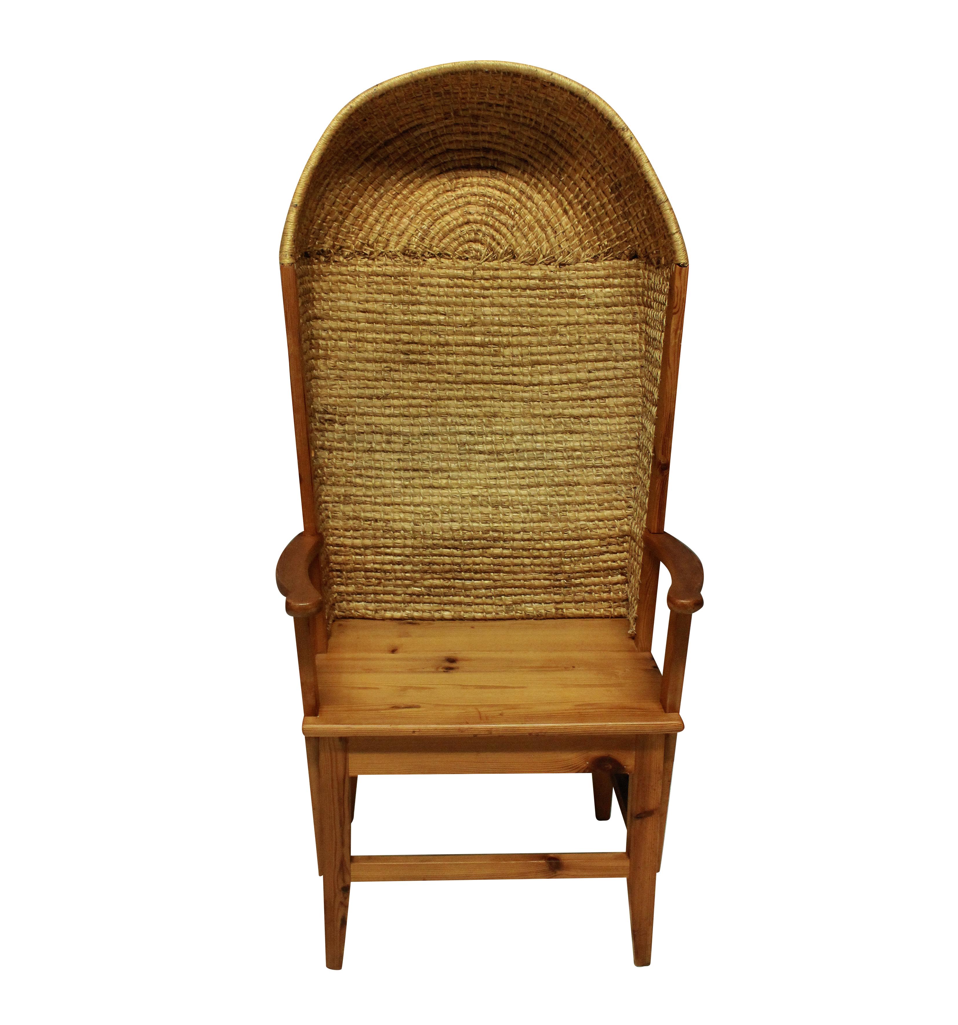 A midcentury Scottish Orkney armchair in pine with woven rush back.