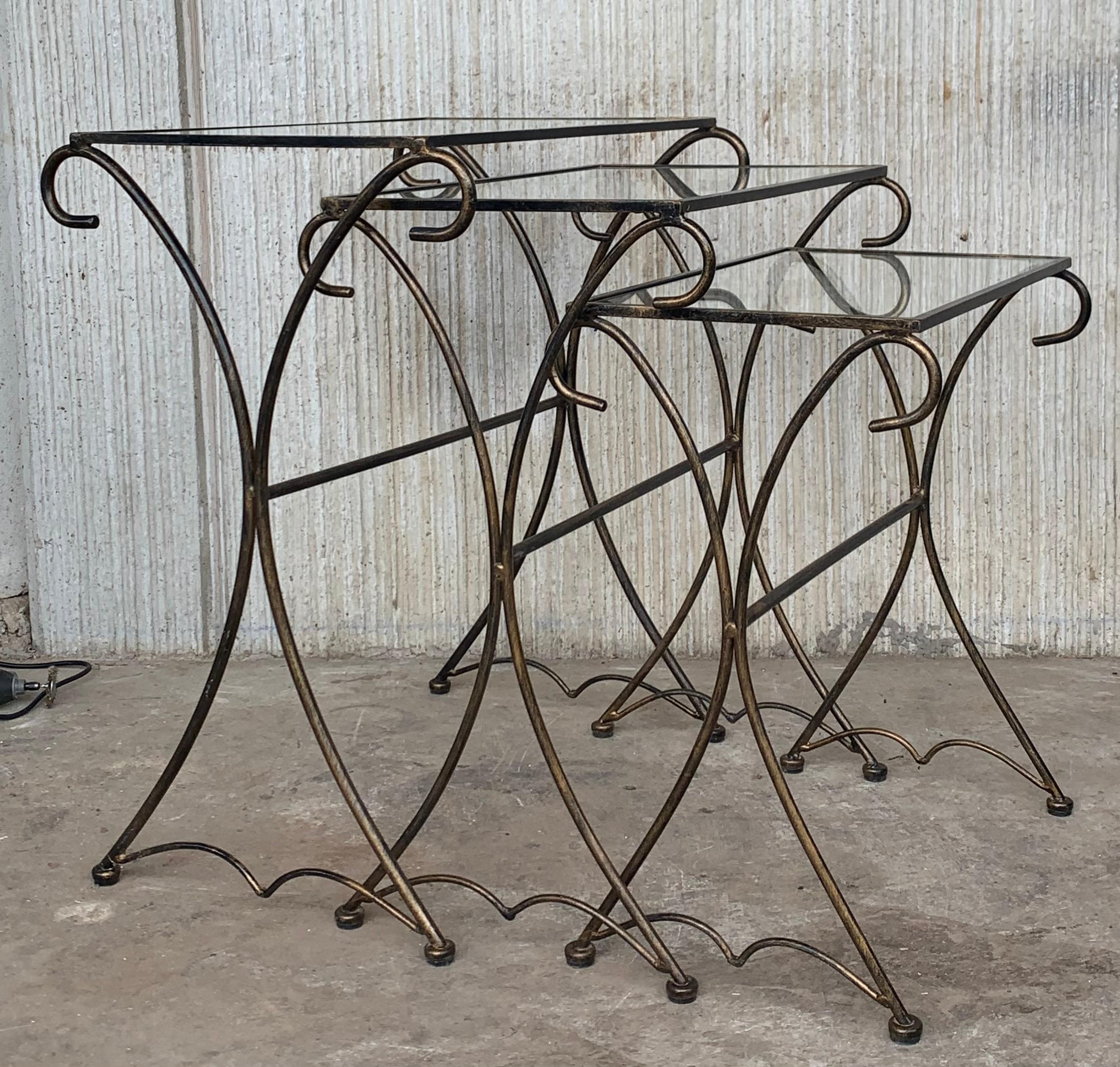 Original 1950s outdoor/patio nesting side table pair with iron scrolling base.
Stylish set of three stacking tables having exaggerated curved legs with metal mesh tops. All three are in very good original condition, showing only light cosmetic