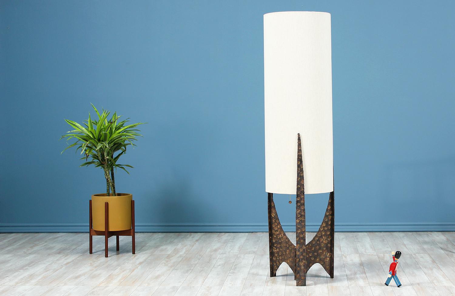 Mid-Century Brutalist floor lamp designed and manufactured in the United States circa 1960’s. This sculptural floor lamp features solid metal textured framework that shows gorgeous patina from age. This brutalist lamp is great for incorporating this