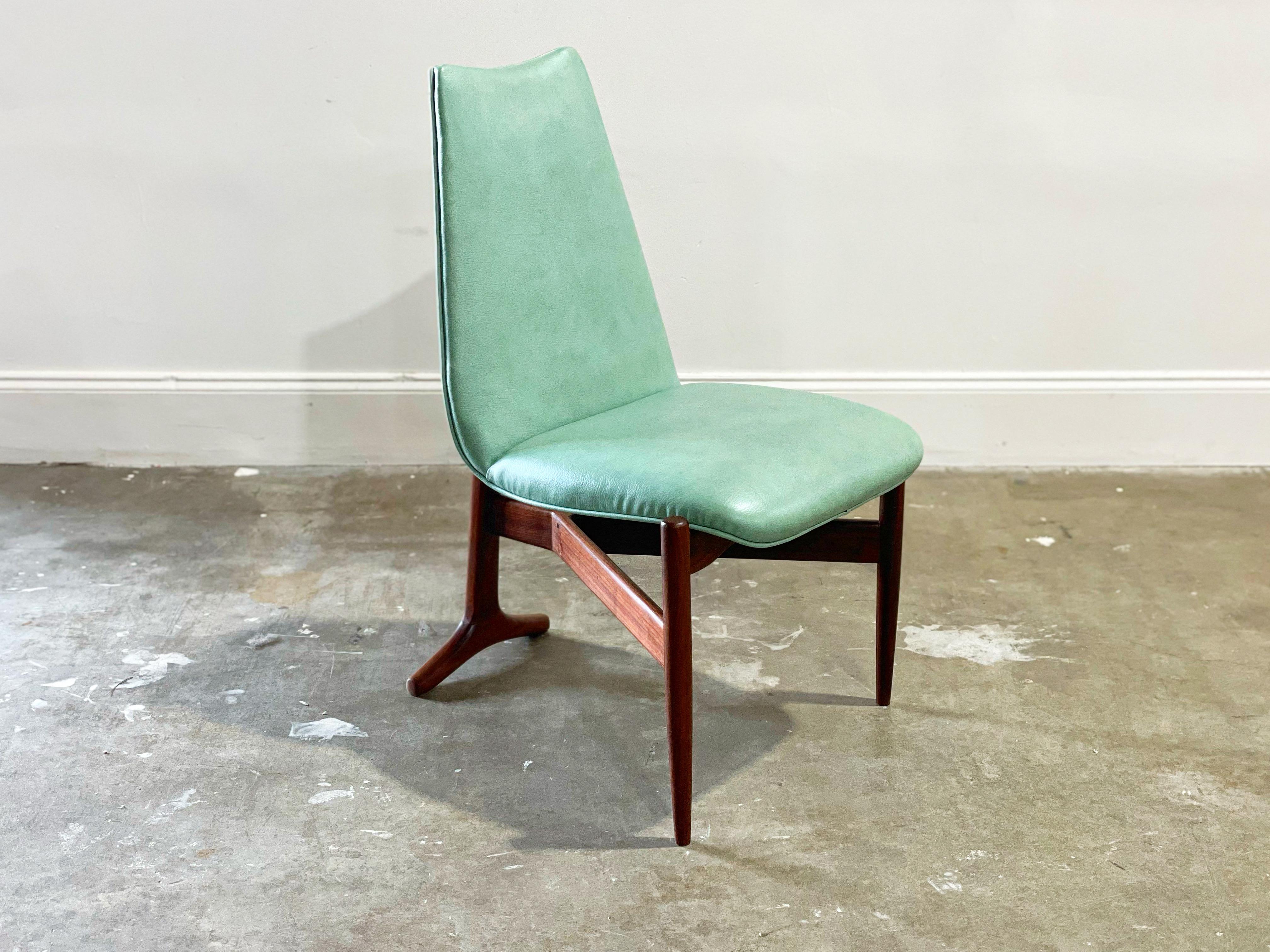 Striking solid walnut floating occasional chair designed by Seymour James Weiner for Kodawood, Miami circa 1964. 
Solid American black walnut frames have been fully restored and are in excellent condition. Original sea foam green naugahyde was deep