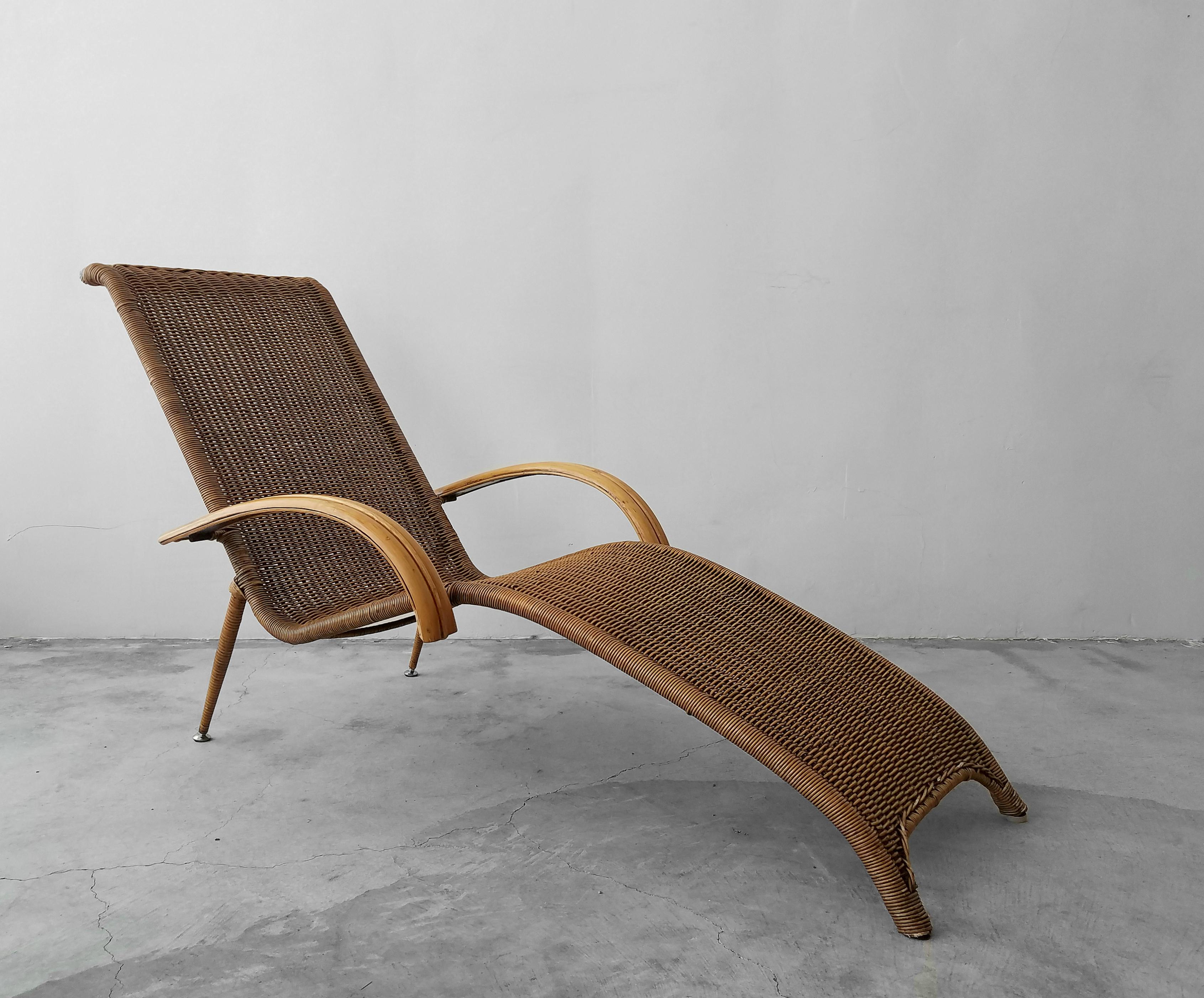 When furniture is more than furniture, it's art. This beautiful sculptural chair deserves to be showcased. An authentic vintage piece in excellent condition. A solid metal frame with woven cane and bamboo arms. This piece would be excellent in any