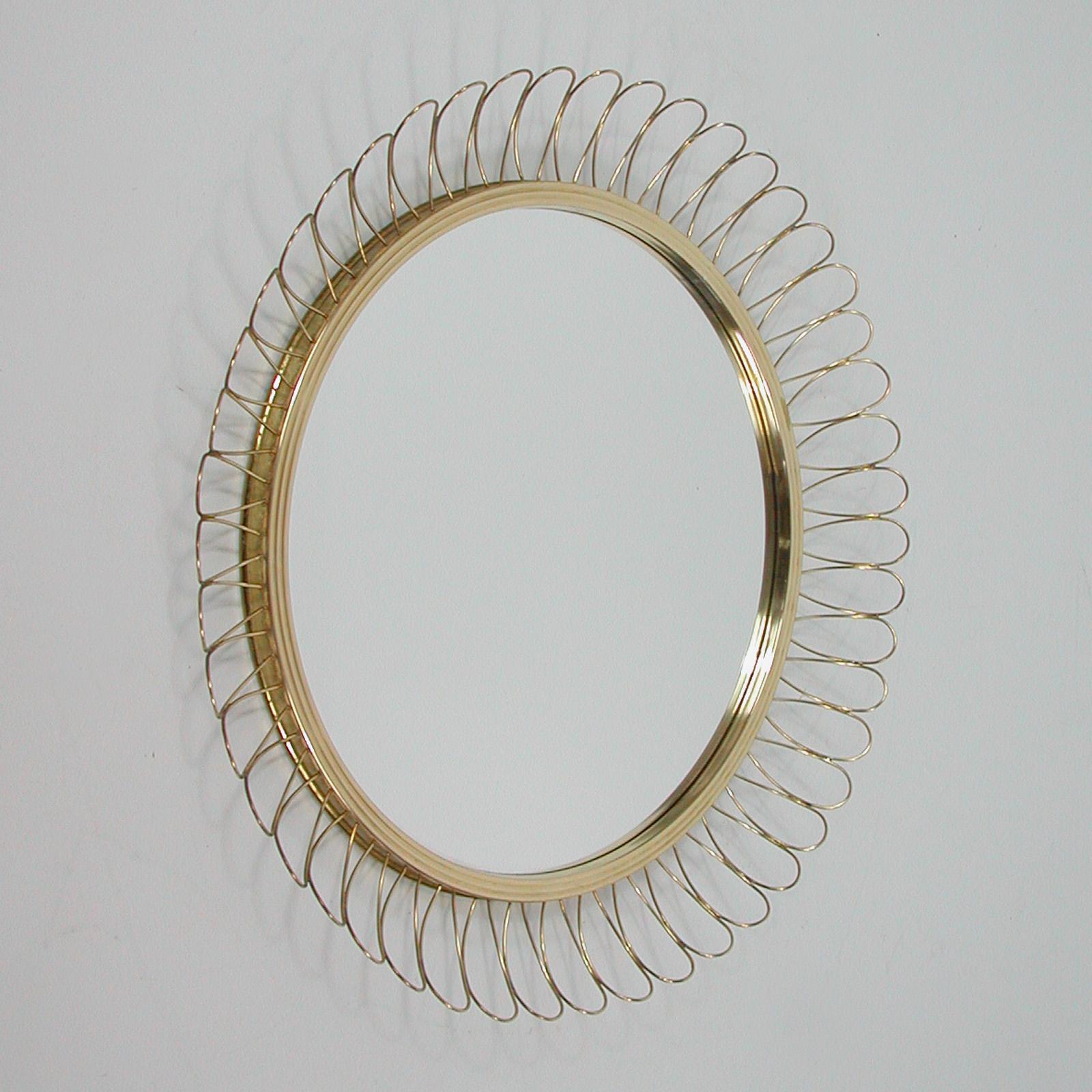 This beautiful brass loop wall mirror was designed and manufactured in Sweden in the 1950s. The brass frame with nice warm vintage patina. The mirror flawless. 

Measures: Diameter app.: 15.8