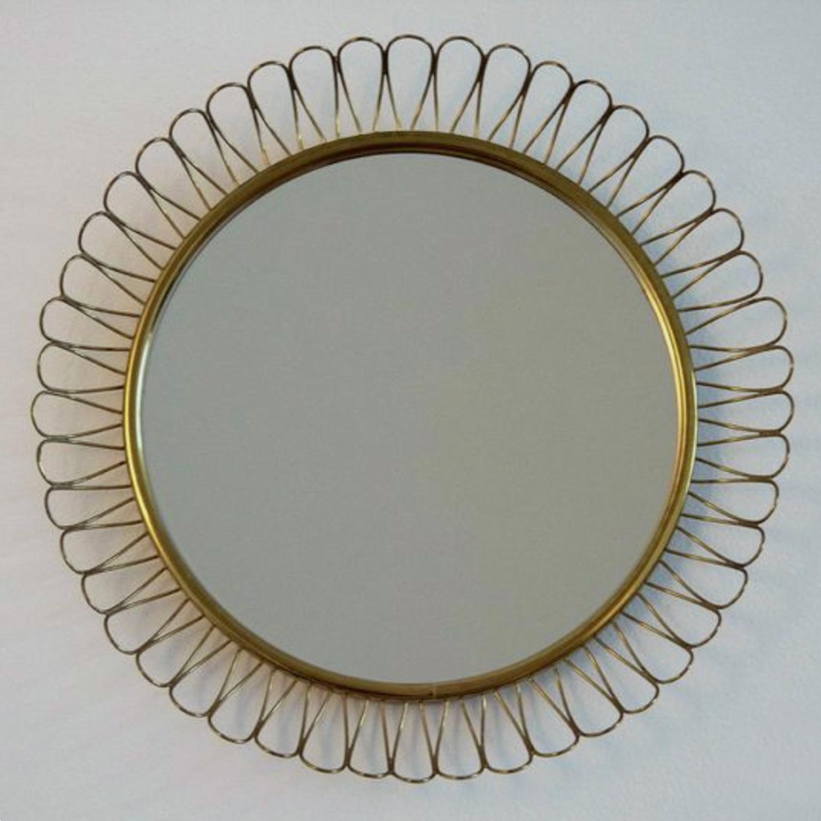This beautiful brass loop wall mirror was designed and manufactured in Sweden in the 1950s. The brass frame with nice warm vintage patina. The mirror glass somehow cloudy due to age. 

Measures: Diameter app.: 12.2