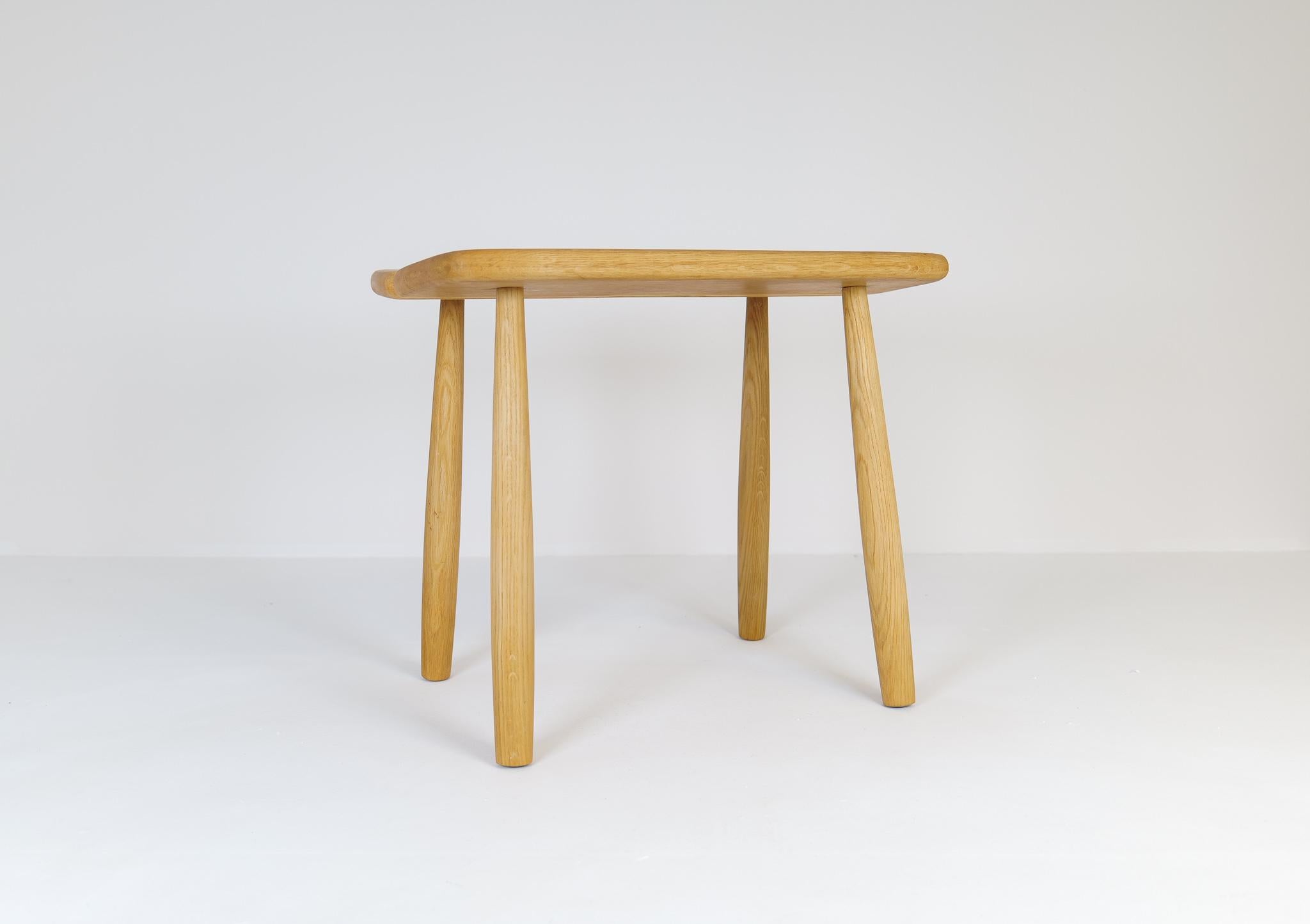 A stool in solid oak with nice complexity in the structure. Shifting grain in the oak gives it a nice look. 
This stool is a good example of the good craftsmanship and minimalistic stile to come in Scandinavian furniture. 

 The oak bench was