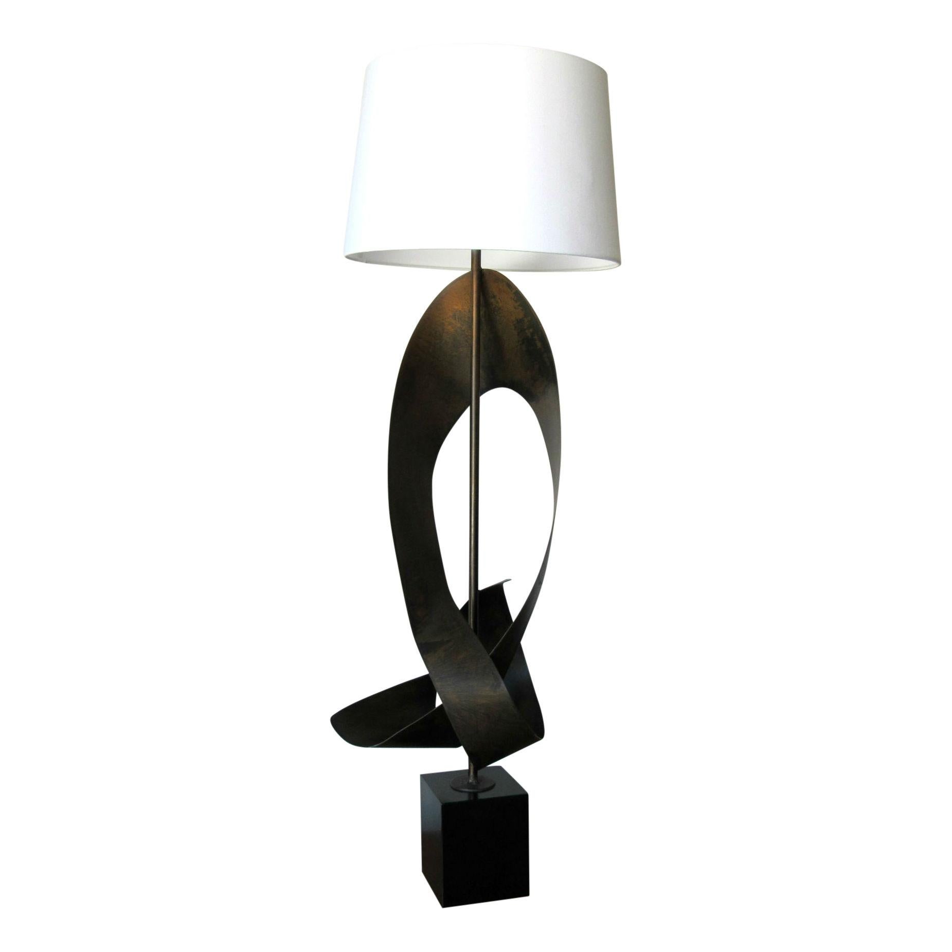Richard Barr and Harold Weiss for the Laurel Lamp Company, but often wrongly attributed to Harry Balmer, this dramatic lamp features torch cut enameled steel mounted on a black enameled wood base. 

