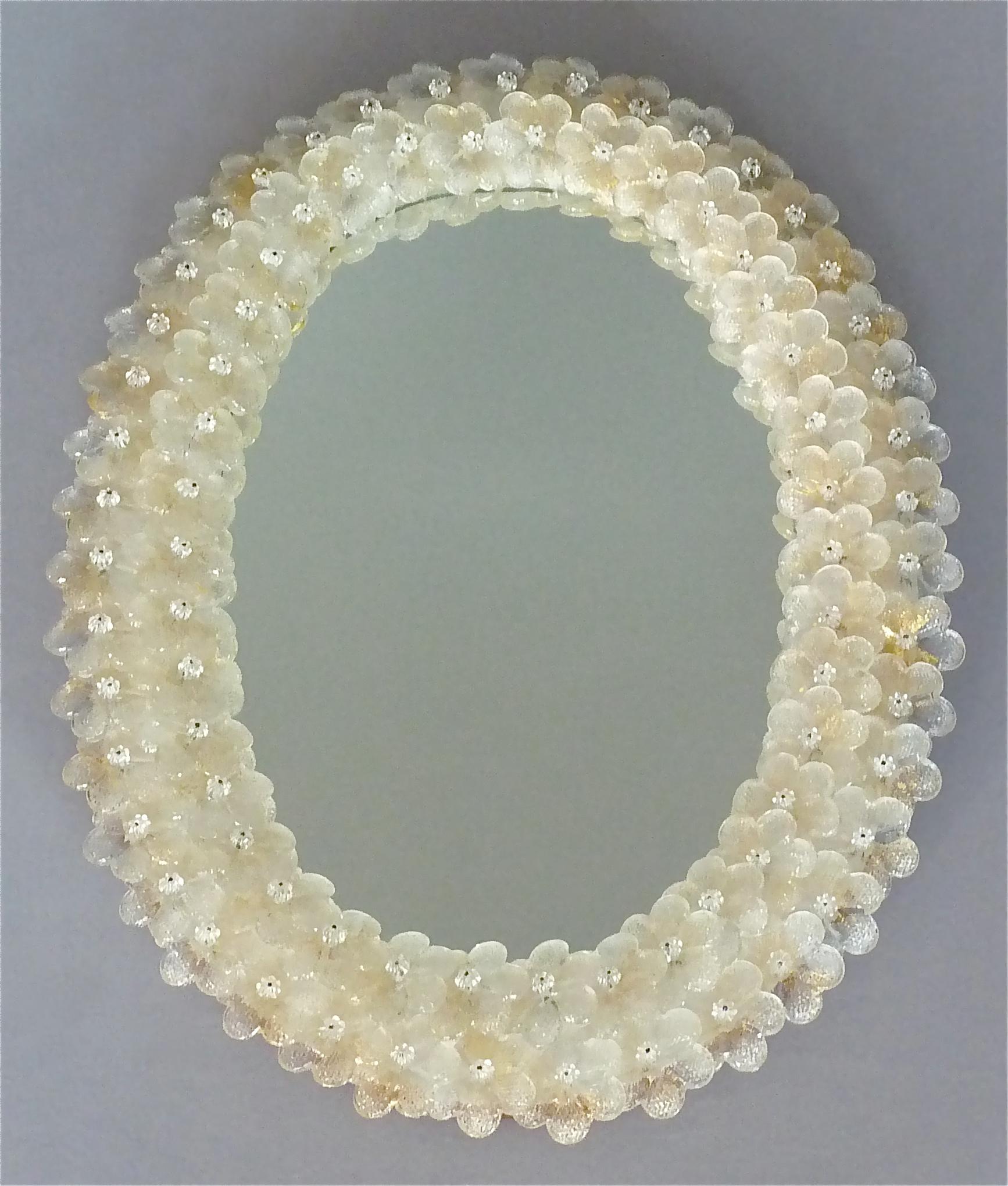 Gorgeous oval Seguso wall mirror with golden and clear handcrafted Murano glass flowers, Italy, circa 1950-1960. This fine Italian wall mirror has Murano glass flowers which are made with 24-carat gold inclusions. It is 55 cm / 21.65 inches tall, 40