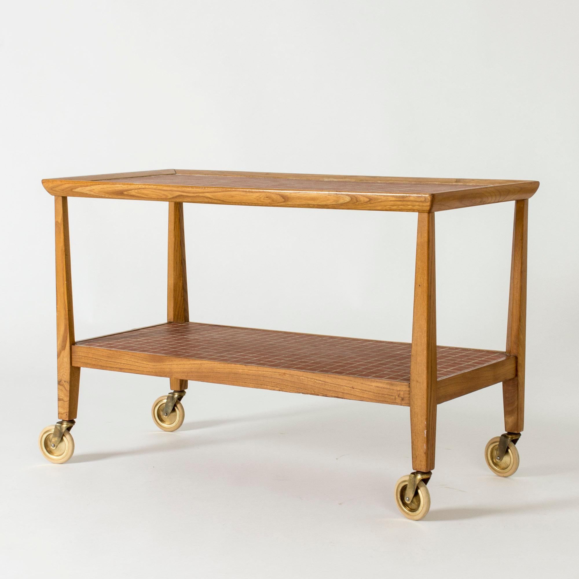 Lovely serving cart or side table by Otto Schulz. Made from mahogany with sleek lines. Table top and shelf with terracotta colored mosaic tiles.