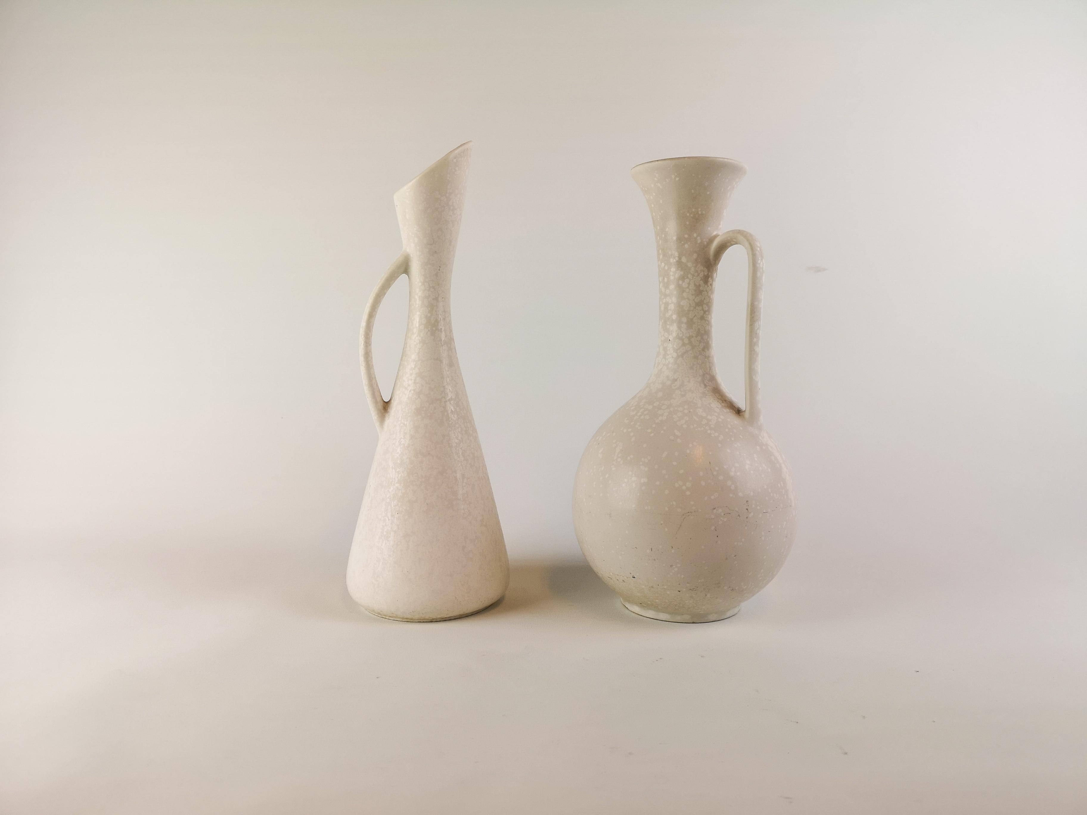 Two wonderful large vases made in Sweden during the 1950s at Rörstrand factory and designed by Gunnar Nylund.

The vase matches each other with the glaze that goes in white and grey. 

Good condition.

Measures: Vase H 30 x D 11 and H 29 x D