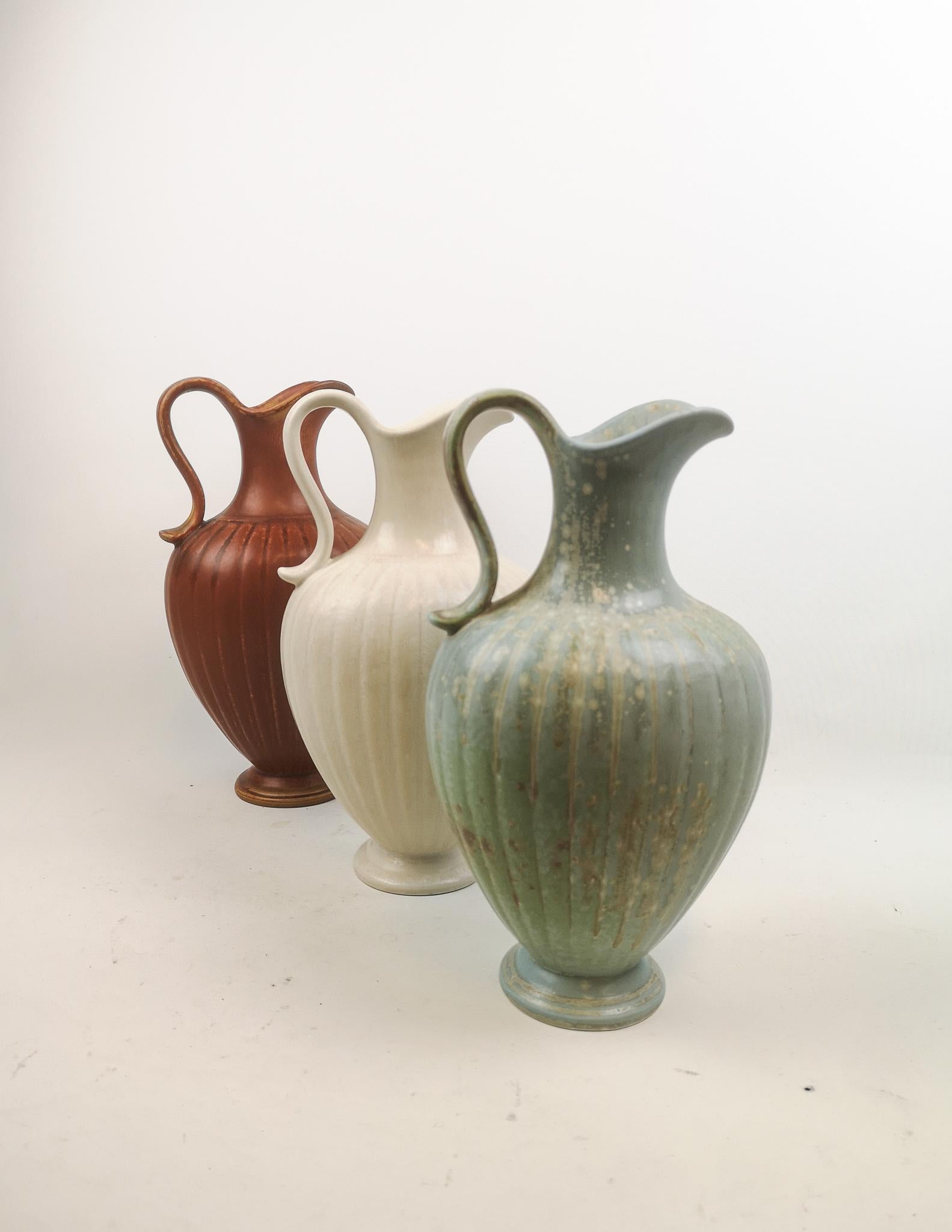 Three wonderful vases from Rörstrand and maker/Designer Gunnar Nylund. Made in Sweden in the midcentury. Beautiful glazed vases in good condition. 

Measures H 30, W 16 cm.