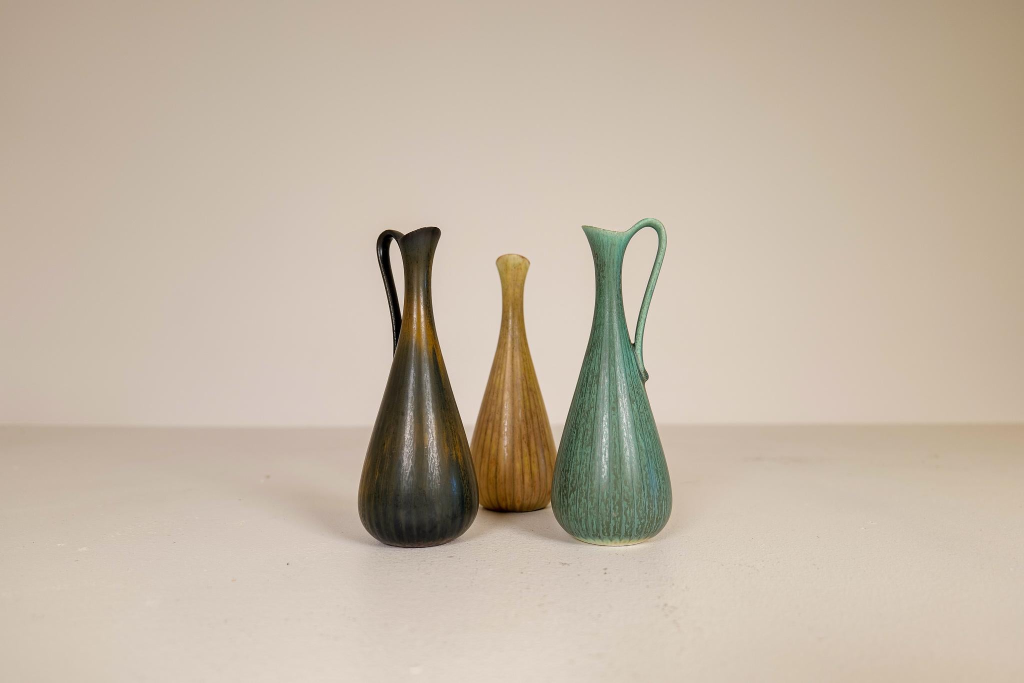 Three wonderful vases from Rörstrand and maker, designer Gunnar Nylund. Made in Sweden in the midcentury. Beautiful, glazed vases in good condition. The craftsmanship and details in these vases/vessels are exceptional good. 

Dimensions: Height 20