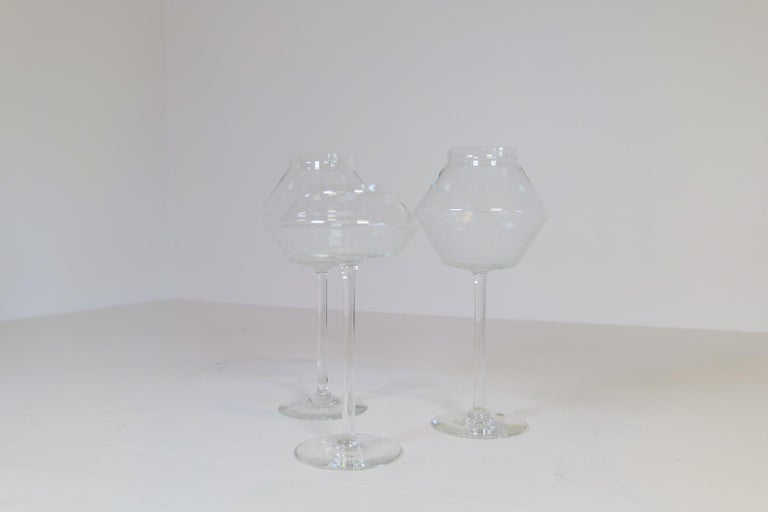 These 3 rare glass pieces were made in Johansfors Sweden and designed by Bengt Orup in the 1950s. The large candleholders are made with clear glass and have white stripes on the lower part of the glass. 
Very nice condition.

Measures: H 33 cm D