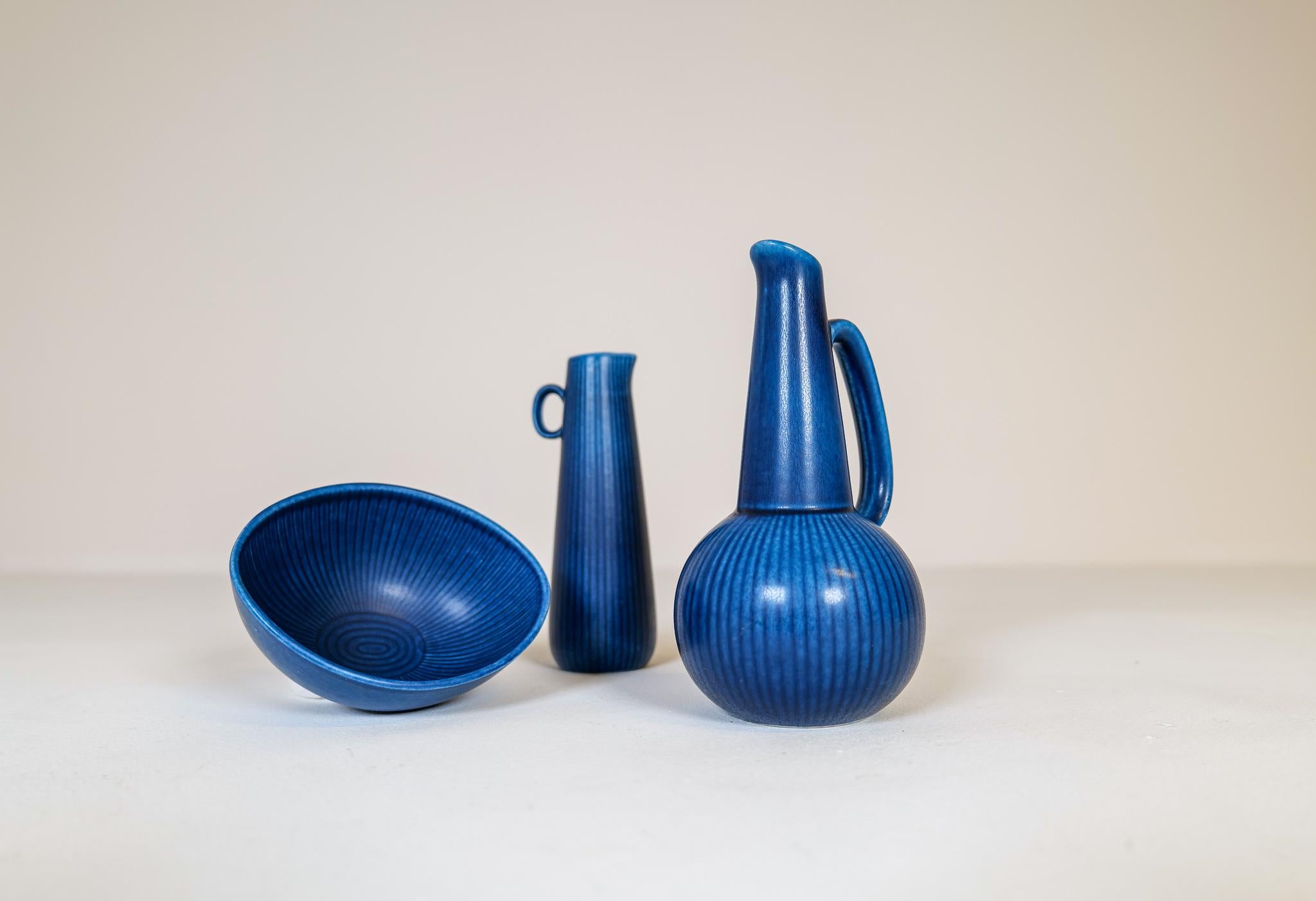 Wonderful blue glaze on these 2 vases and bowl from Rörstrand Sweden, designed by Gunnar Nylund in the 1950s.

They are all in good vintage condition. 

Dimensions: Large vase H 18 cm, D 6 cm. Bowl W 12 D 10 H 6.
 