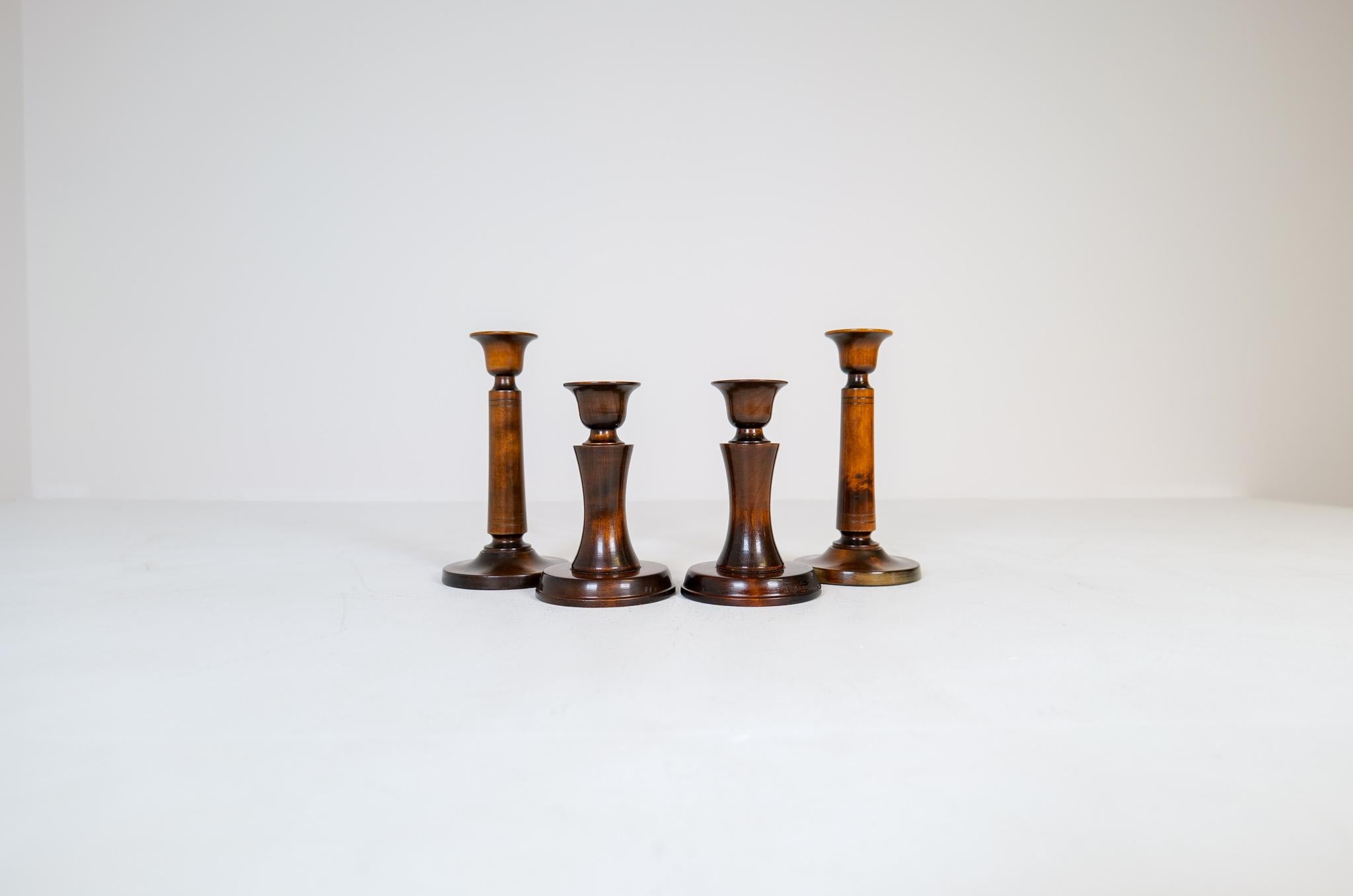 Set containing 4 candlesticks designed by the famous Carlm Malmsten. Made in lacquered birch are these modest yet highly crafted candlesticks made in Sweden during the 1960s. 

Good vintage condition, lacquer has some wear. 

Dimensions: Height