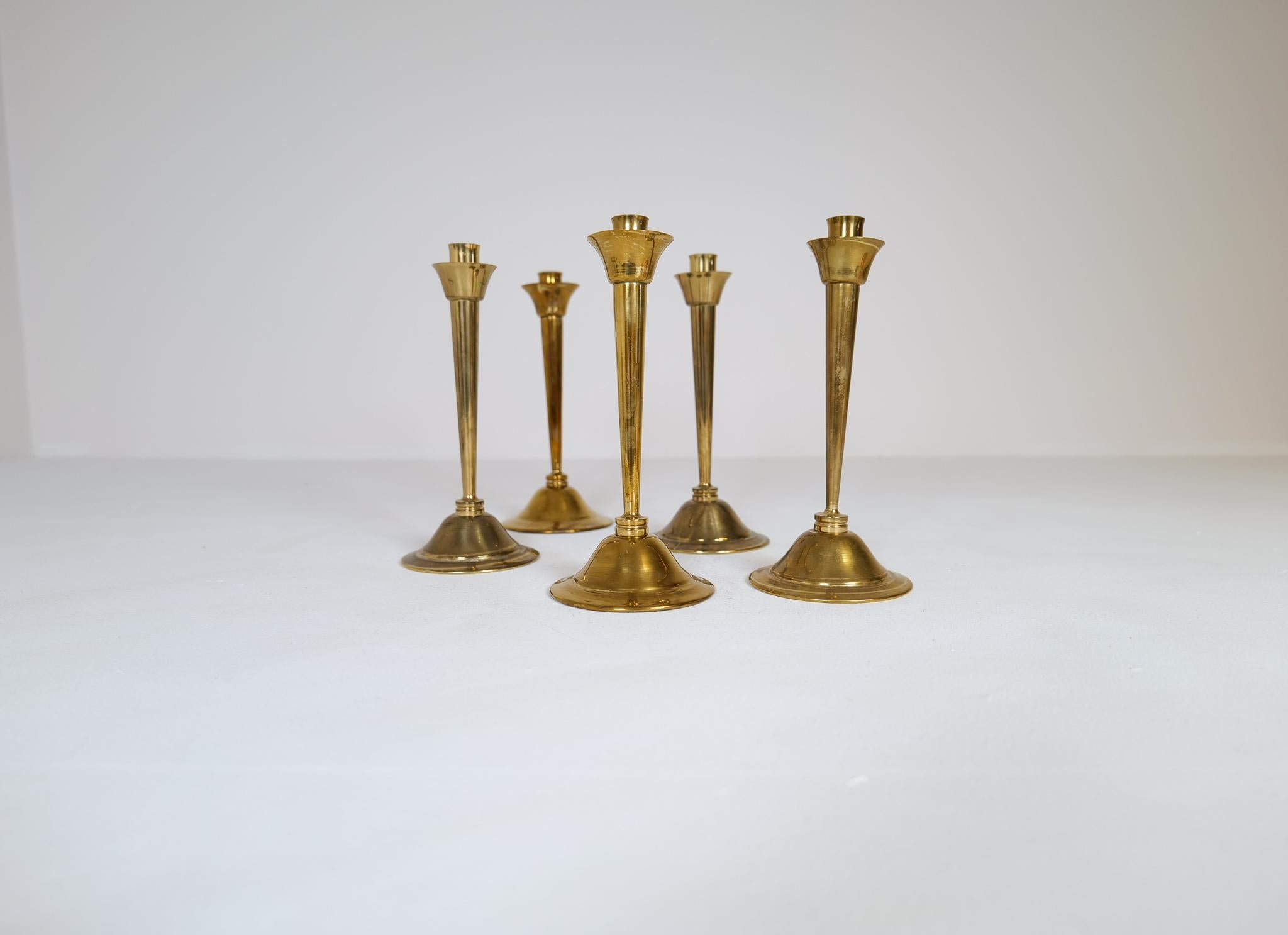 Set of 3 brass candlesticks designed by Lars Holmström. Produced by Lars Holmström in Arvika, Sweden. All of them are signed. Wonderfully worked in the shaped and handmade brass pieces. 

Signs of wear and use. 

Dimensions: Height 21 cm Base 11