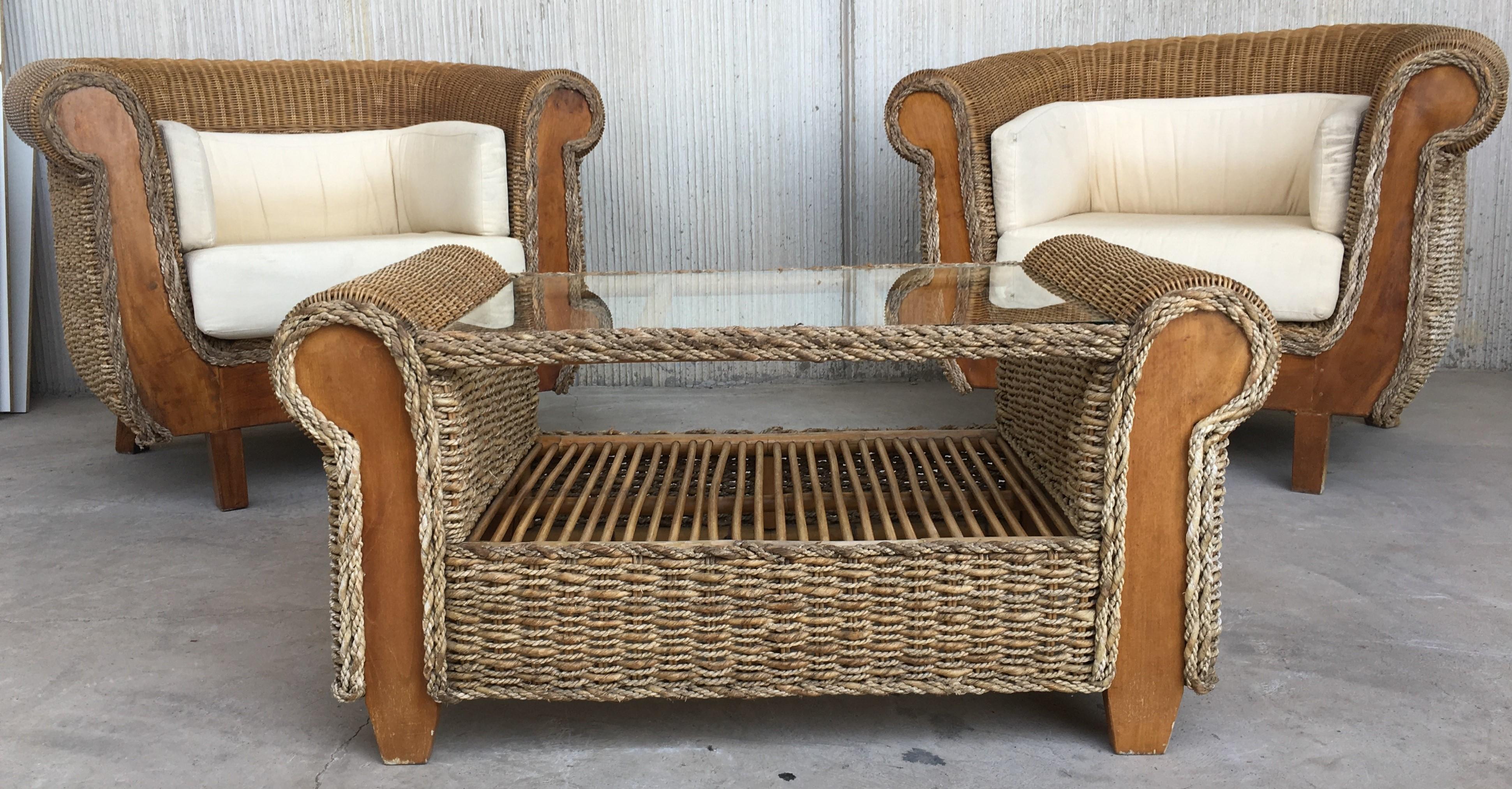 Midcentury set of big armchairs and coffee table, rattan and wood.
Living room set.

Table measurements: Height 21.65in, deep 22.44in, wide 42.12 in.