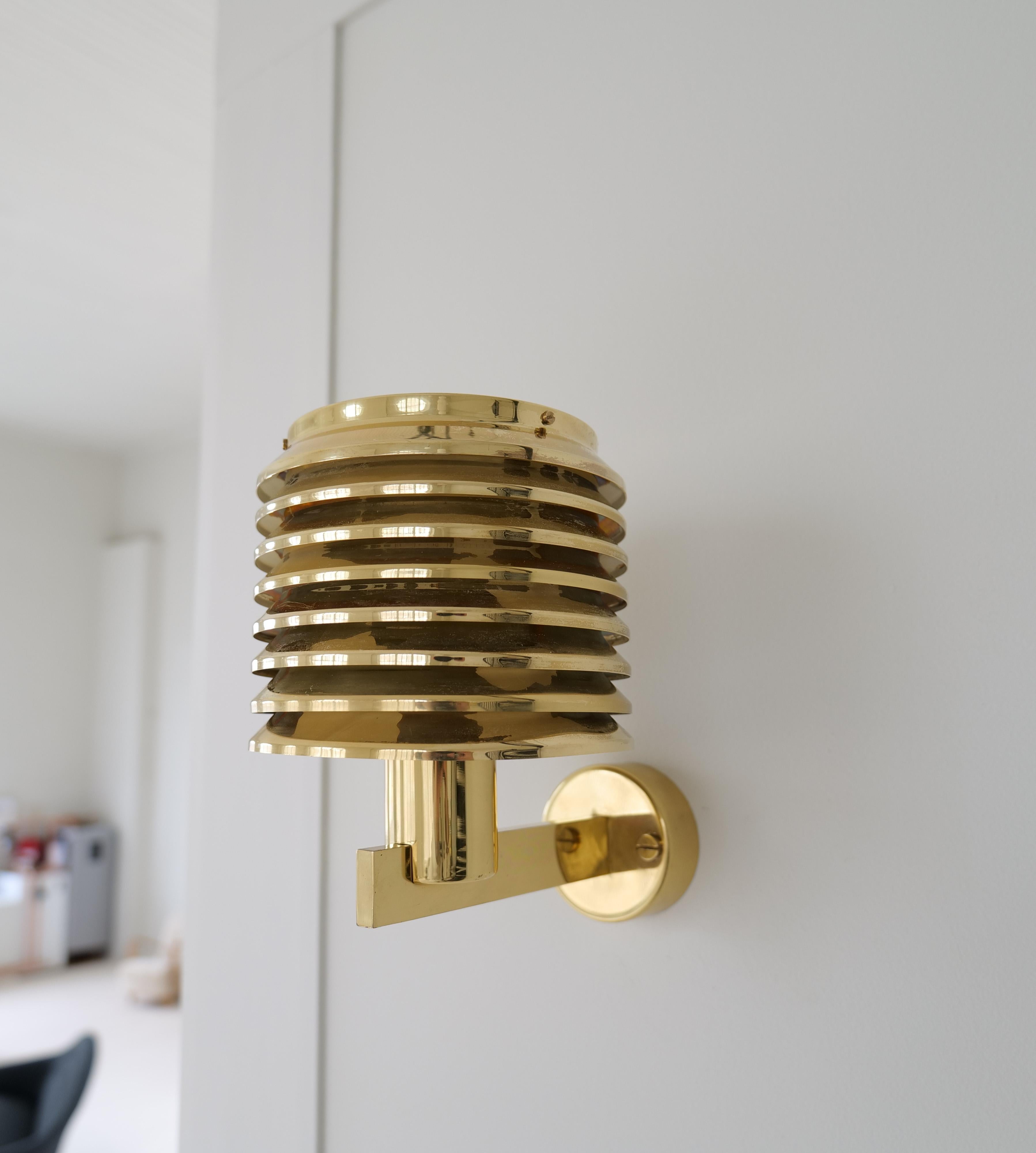 A stunning pair of wall mounted lamps with base and laminated shade in brass. 

Vintage condition, with wear on the brass. They have all been a part of interior 
decoration in a hotel in Oslo Norway. 

Measures: Height: 9 in. (23 cm) Width 6.7