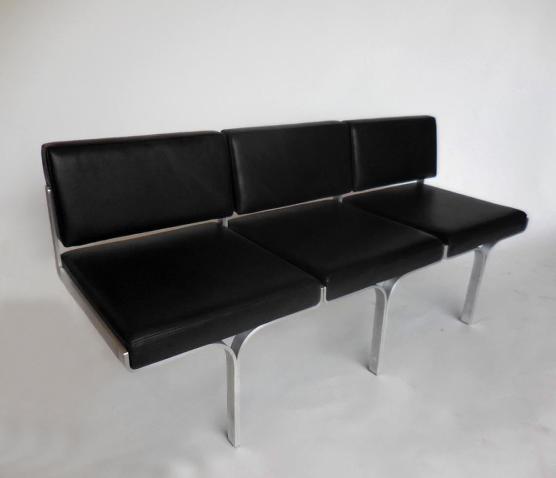 Midcentury settee, newly refurbished and upholstered in black calf skin. Made by J.G. Furniture Co., Brooklyn, NY. Cast aluminium legs. In great condition.