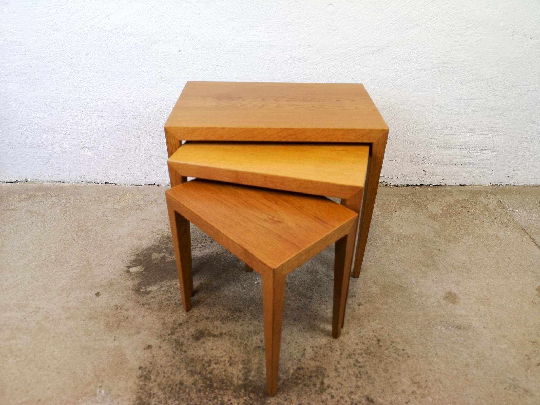 These nesting tables was produced in Denmark at Haslev Mobelsnedkeri. Its designed by Severin Hansen. His designed is easily recognized if you look at where the legs meet the top. Perfectly match they are and makes the table look like a piece of