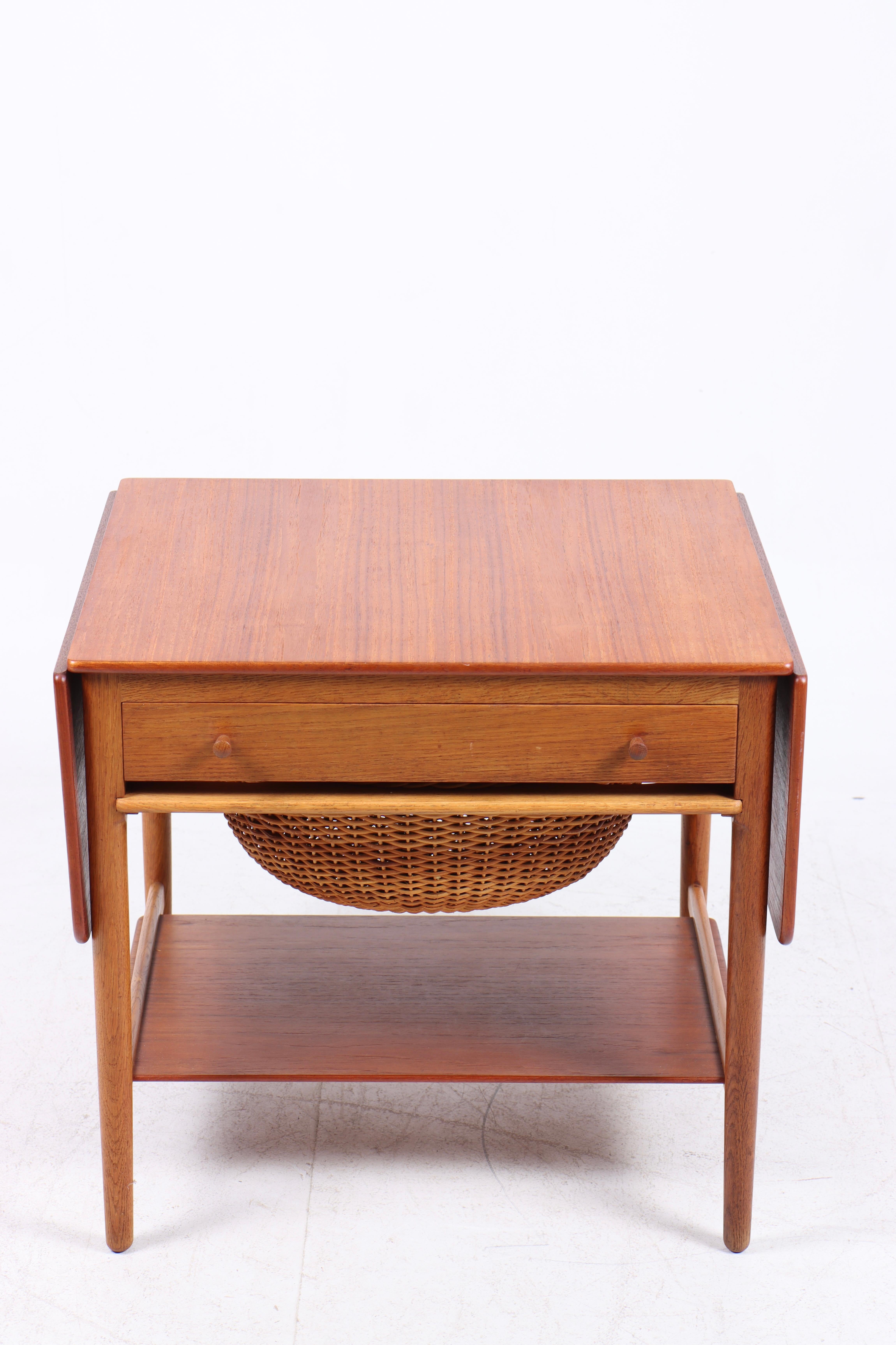Sewing table in solid teak and oak, designed by Hans Wegner and made by Andreas Tuck cabinetmakers. Great original condition.