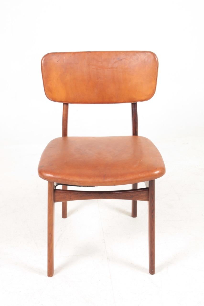 Side chair in rosewood and patinated leather, designed by Kai Kristiansen and made by Gustav Bertelsen cabinetmakers. Great original condition.