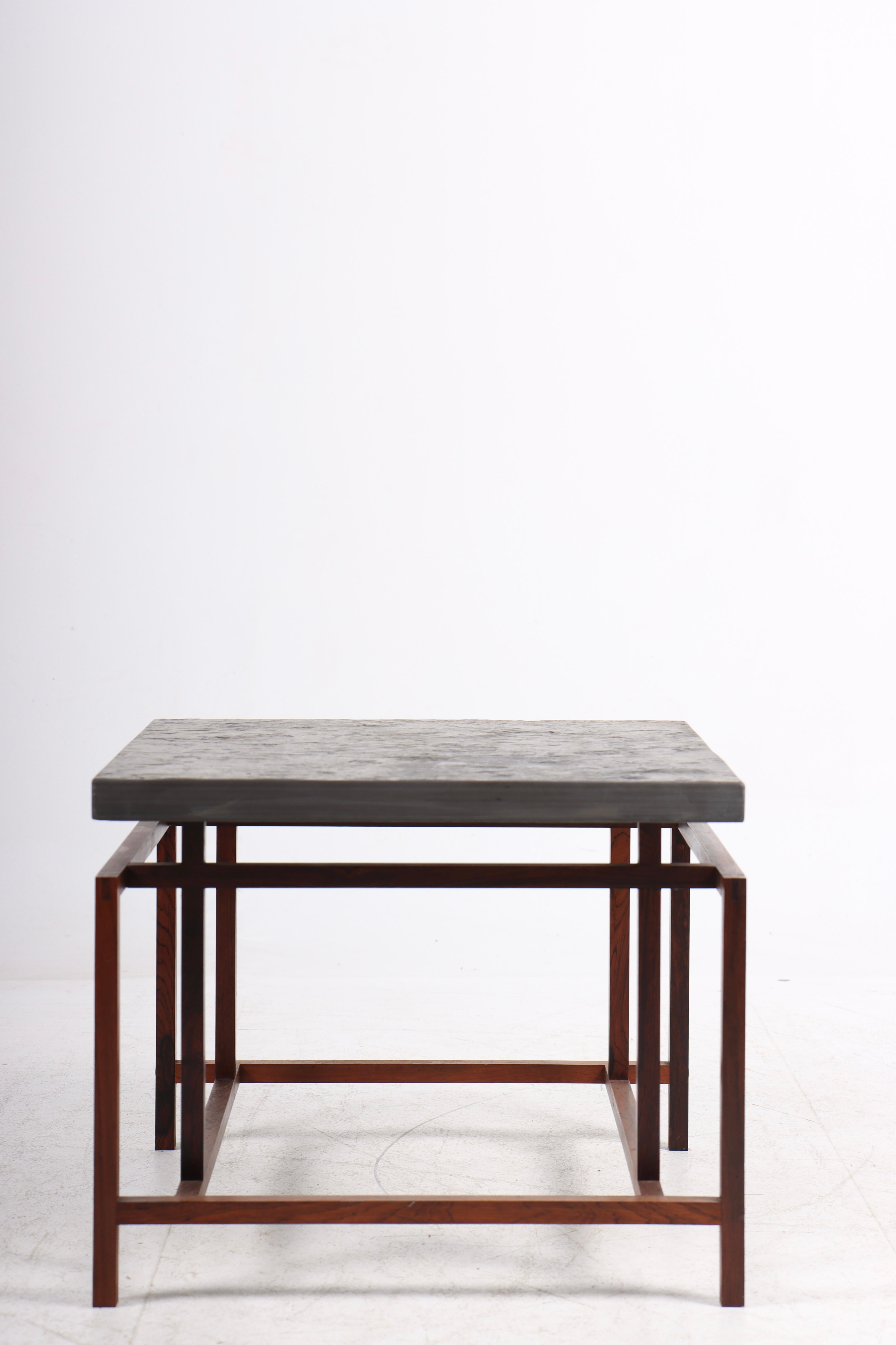 Side table in rosewood and top of slate. Designed by Henning Nørregaard, in the 1960s. Great condition.