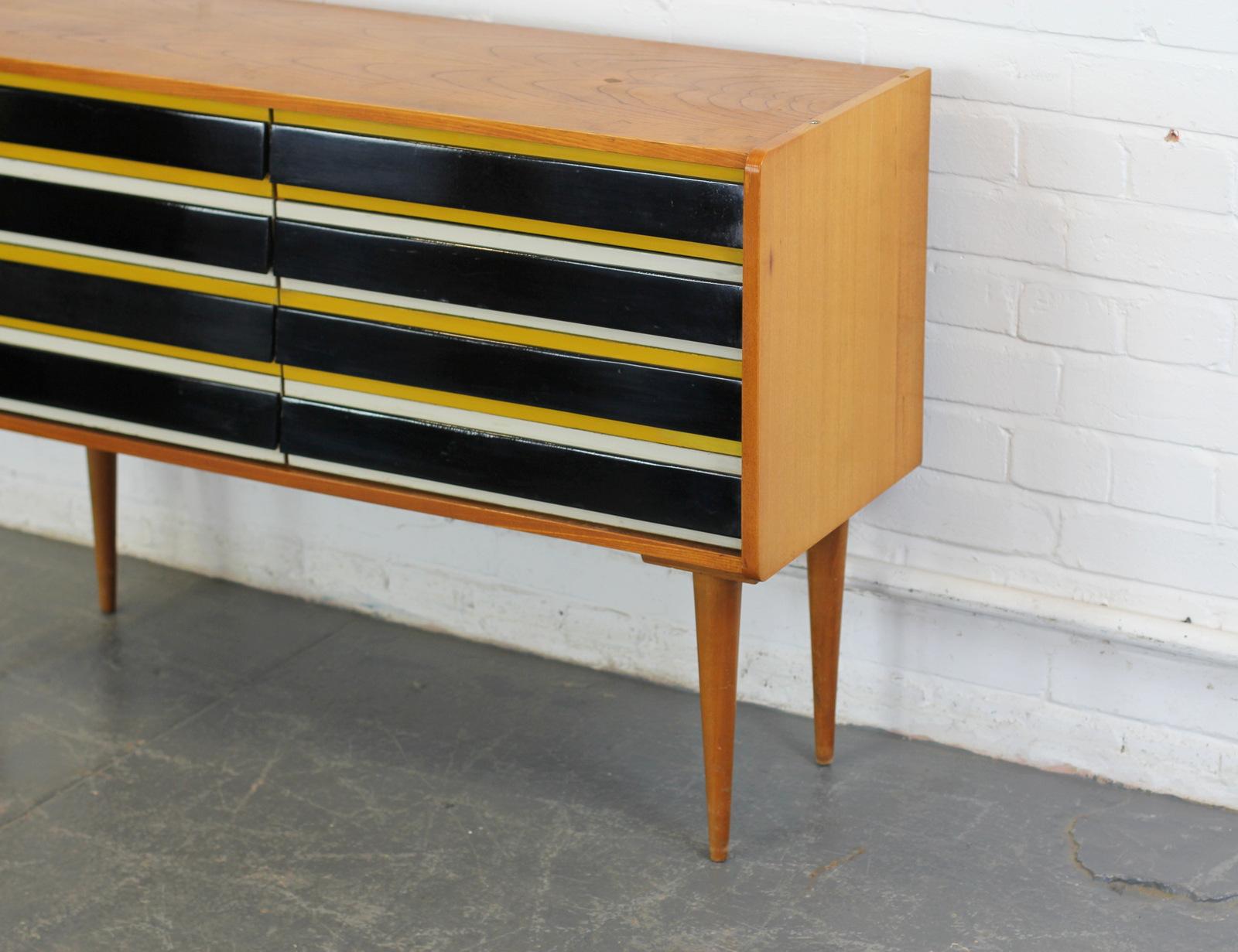 Midcentury sideboard by Jiri Jiroutek, circa 1960s

- Atomic legs
- 8 drawers
- Designed by Jiri Jiroutek
- Czech, Dated 1961
- 110cm long x 38cm deep x 76cm tall

Condition Report

Only some minor cosmetic wear.