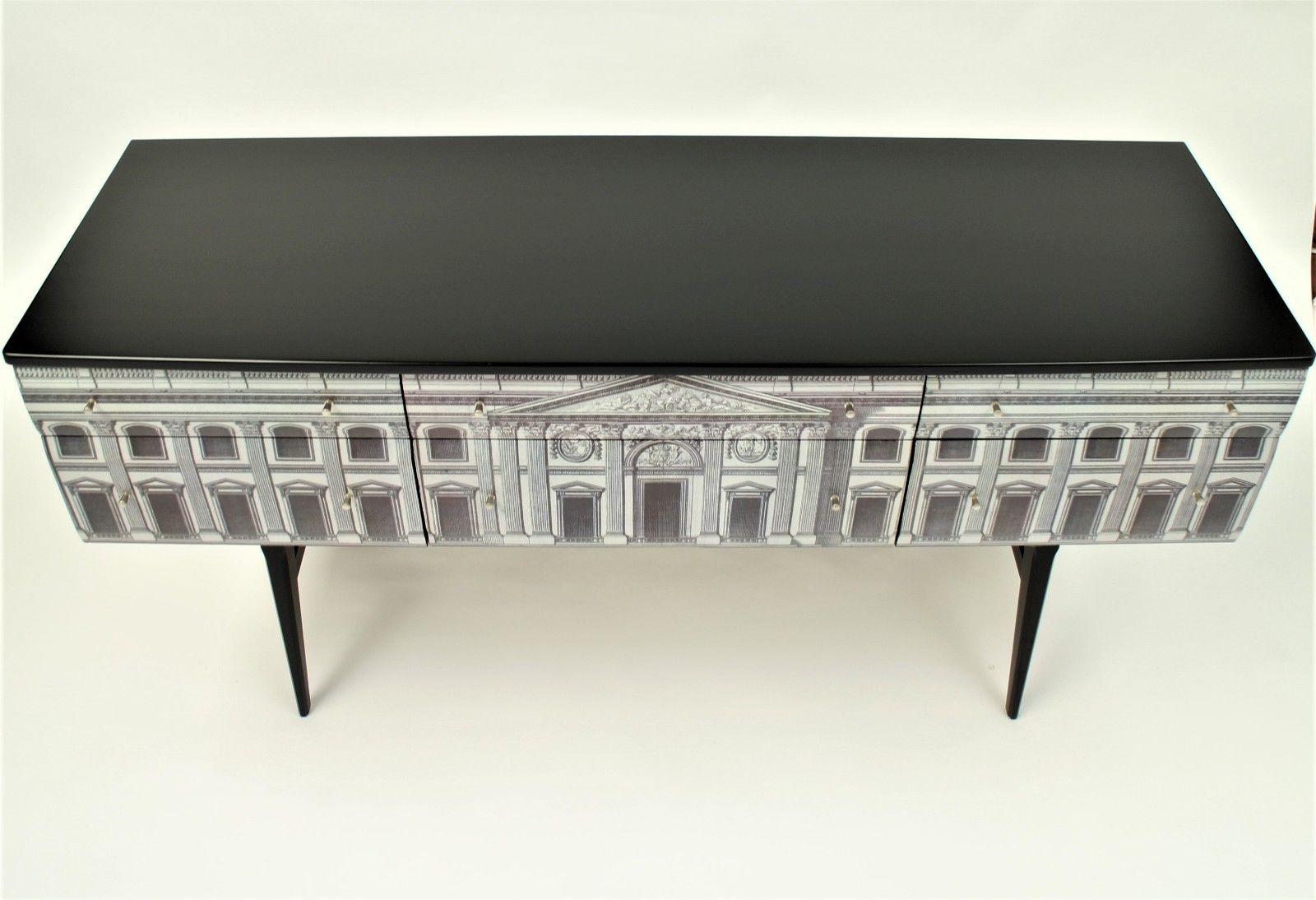 Here we have a 1960s teak sideboard dresser credenza of quality, transformed to a creative piece of art,
Created with a Fornasetti Theme, the building artwork to six draws.
With extremely stylish retro legs and New Italian Nichol handles.
This