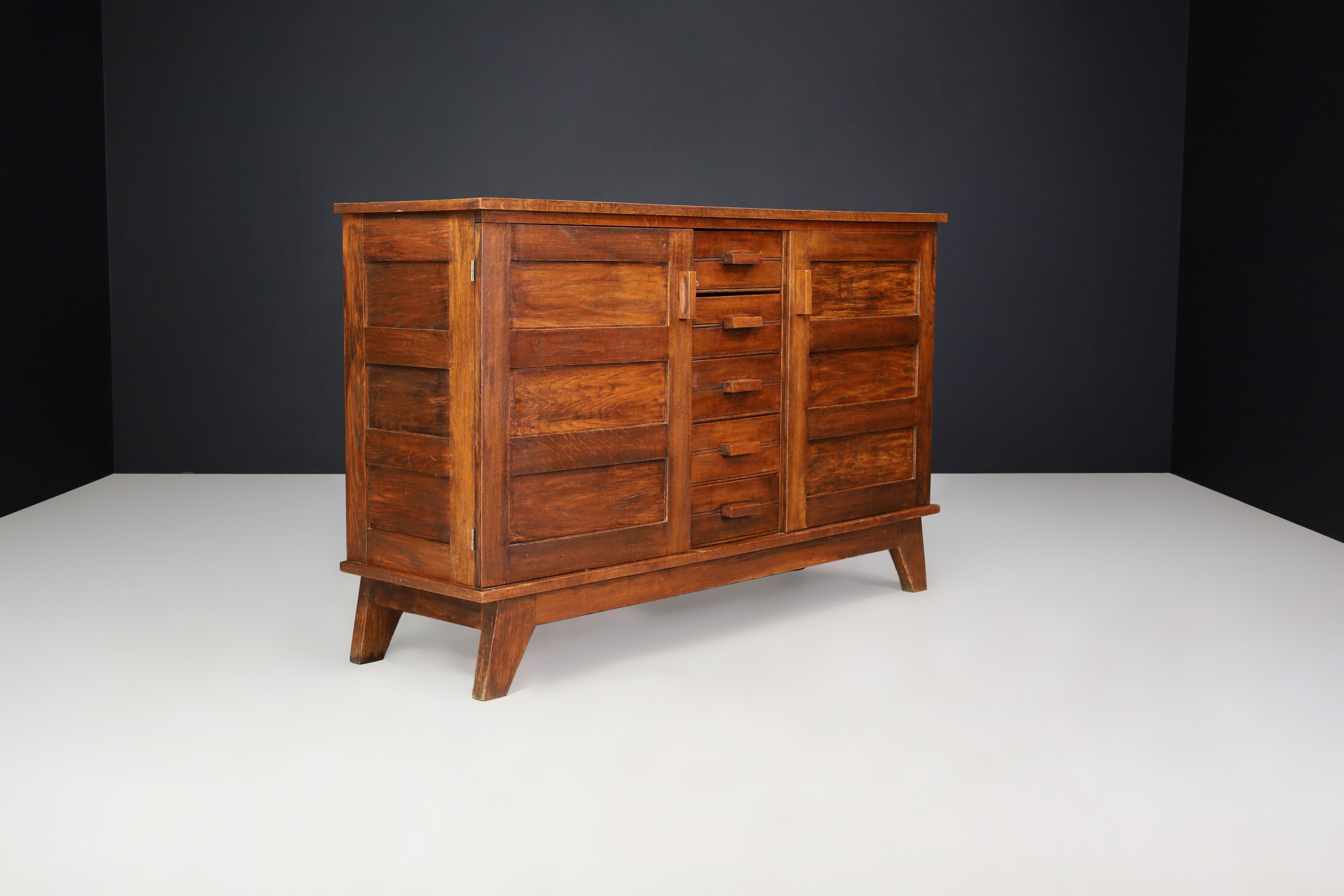 Midcentury sideboard in patinated French oak by René Gabriel, France, 1940s

This mid-century sideboard is made of French oak and was designed by René Gabriel in France during the 1940s. It was created as part of a collection of emergency furniture