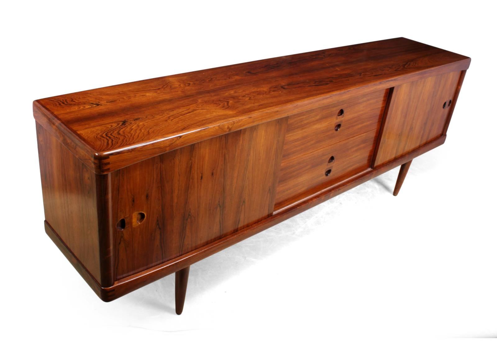 Midcentury sideboard in rosewood by Bramin
A rosewood sideboard produced in Denmark in the mid-1960s by Bramin, the sideboard has two sliding doors with adjustable shelves behind and four central drawers

The sideboard has been professionally