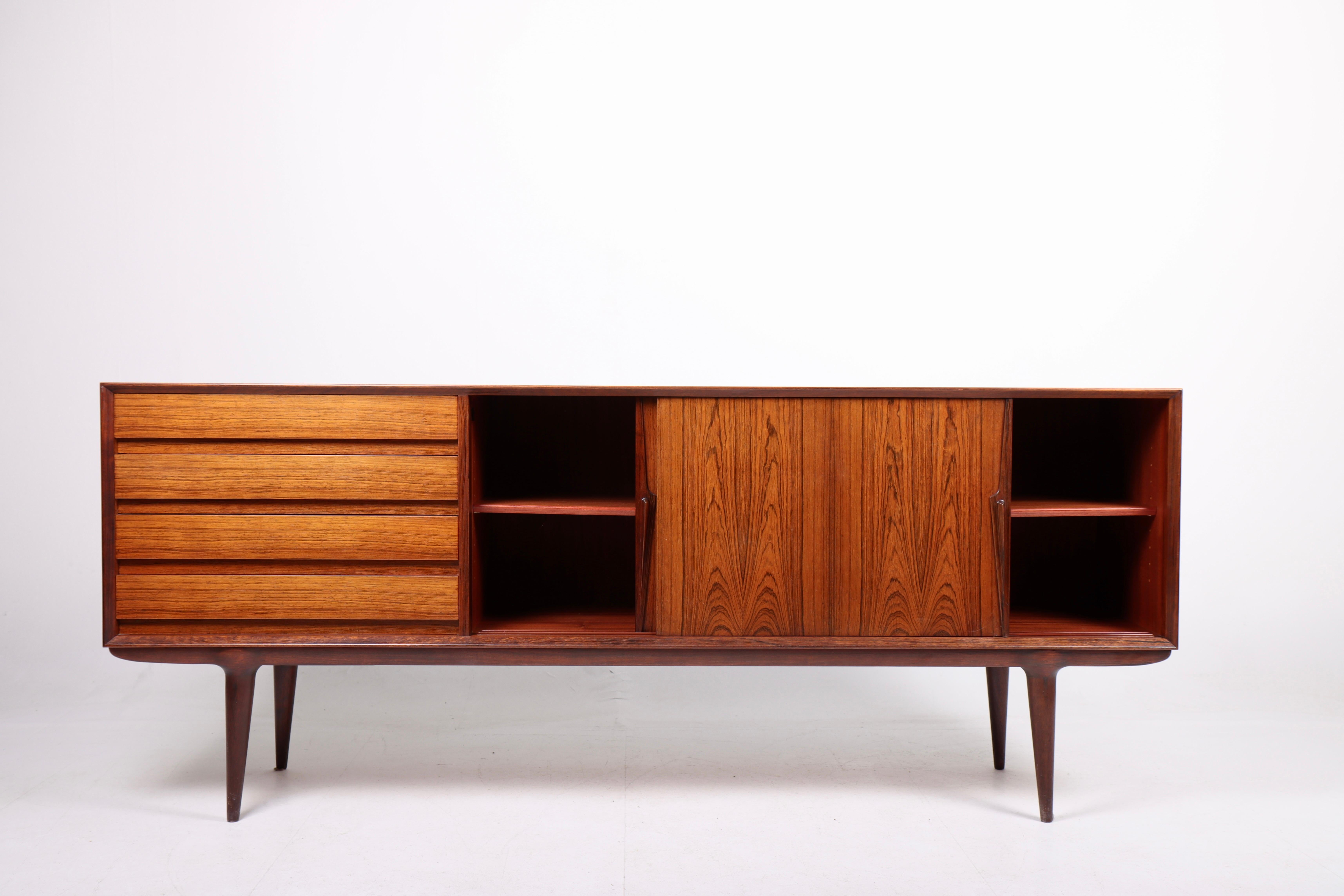 Great looking sideboard in rosewood designed by Gunni Oman for Oman Jun, Denmark in 1960s. Great original condition.