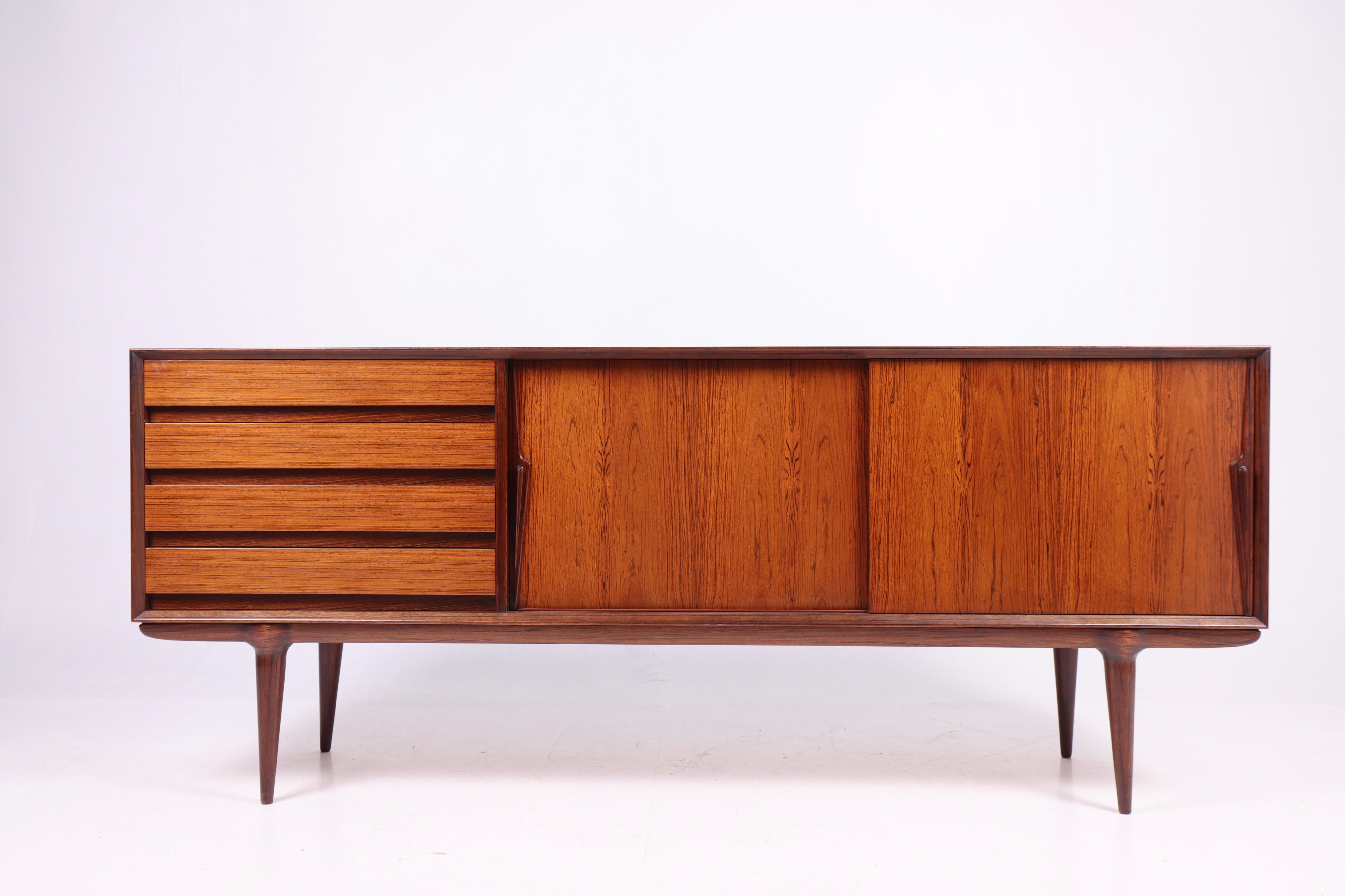 Great looking sideboard in rosewood designed by Gunni Oman for Oman Jun, Denmark in 1960s. Great original condition.