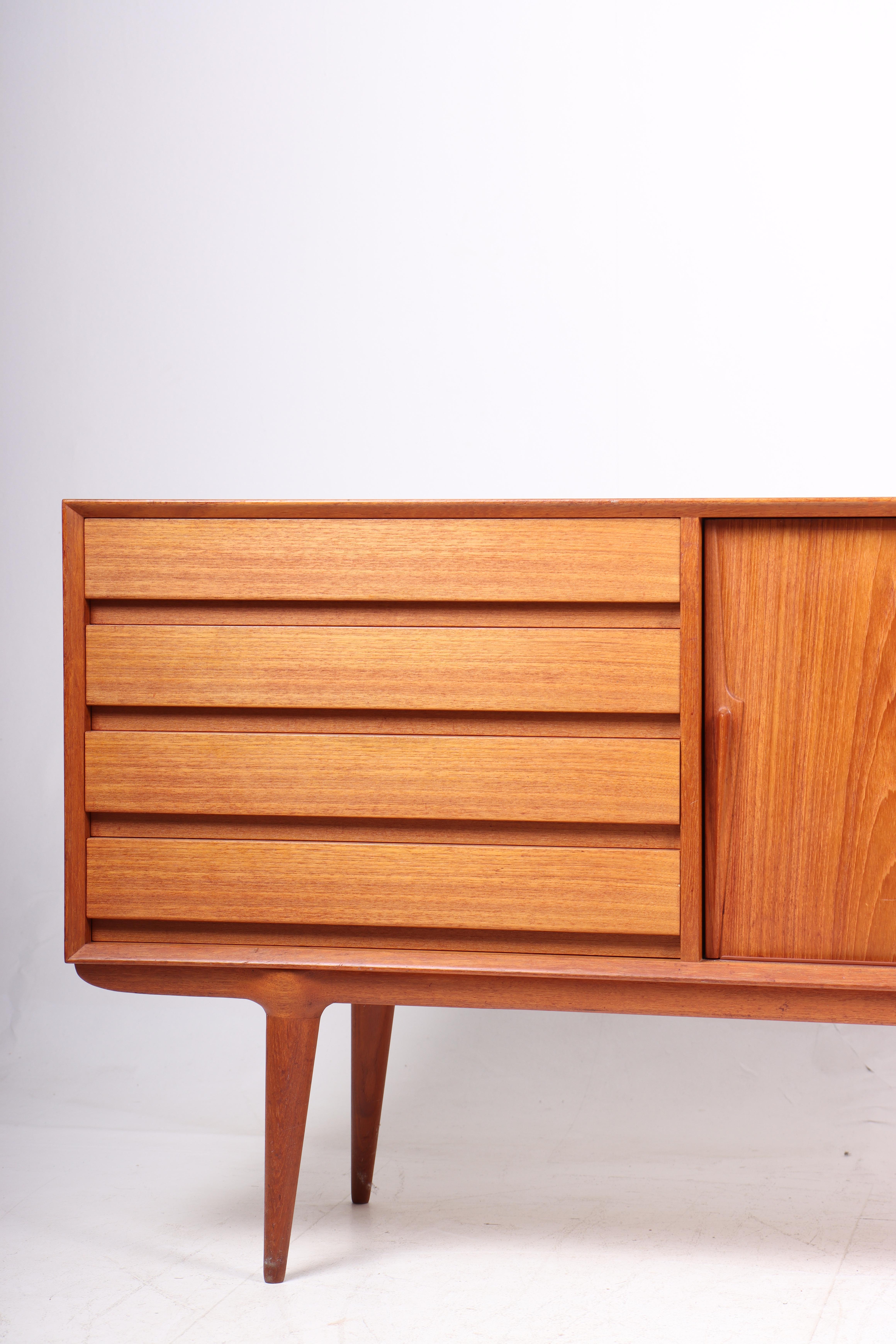 Great looking sideboard in teak designed by Gunni Oman for Oman Jun, Denmark in 1960s. Great original condition.