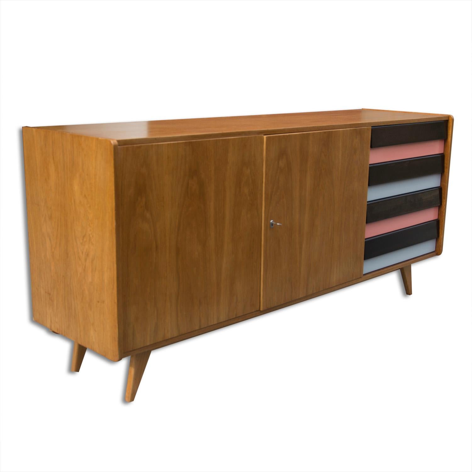 This is a vintage midcentury Czechoslovak sideboard, model number U-460. It was made in the 1960s and produced by Interier Praha. This model is associated with the world-renowned EXPO 58 and Brussels period. It features a four plastic colored