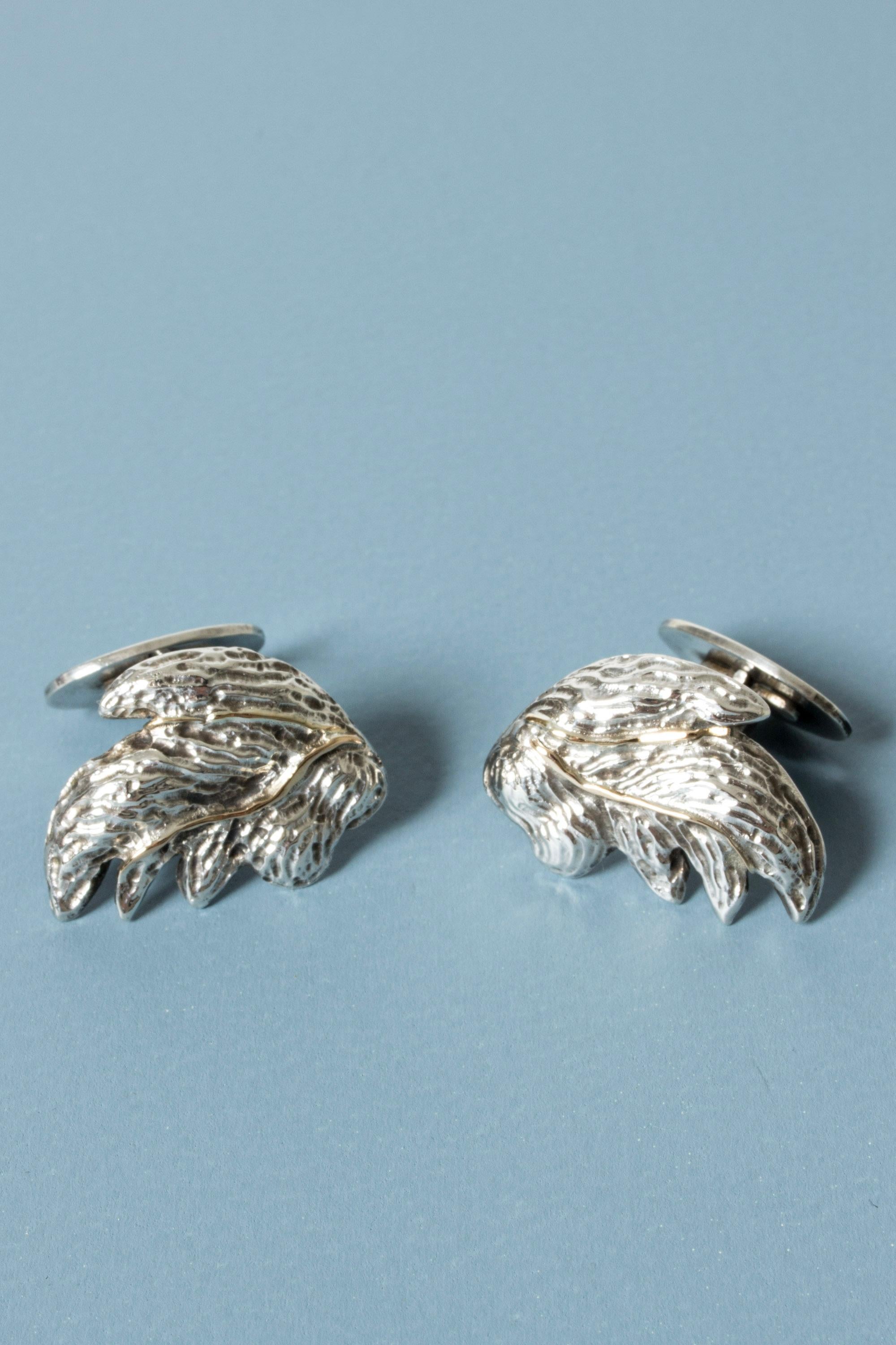 Beautiful, large silver cufflinks by Olle Ohlsson, in an organic leaf form. Lovely details with a gold vein through the center.

Olle Ohlsson is a Swedish silversmith with a unique artistic expression that he has consistently strived to evolve and