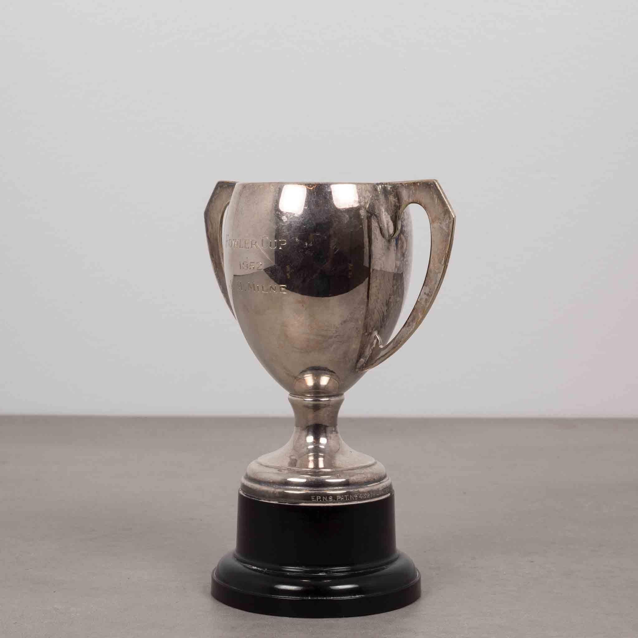 About
This is an original loving cup trophy. The body is silver plated with a black base and stylized handles. The trophy is inscribed 