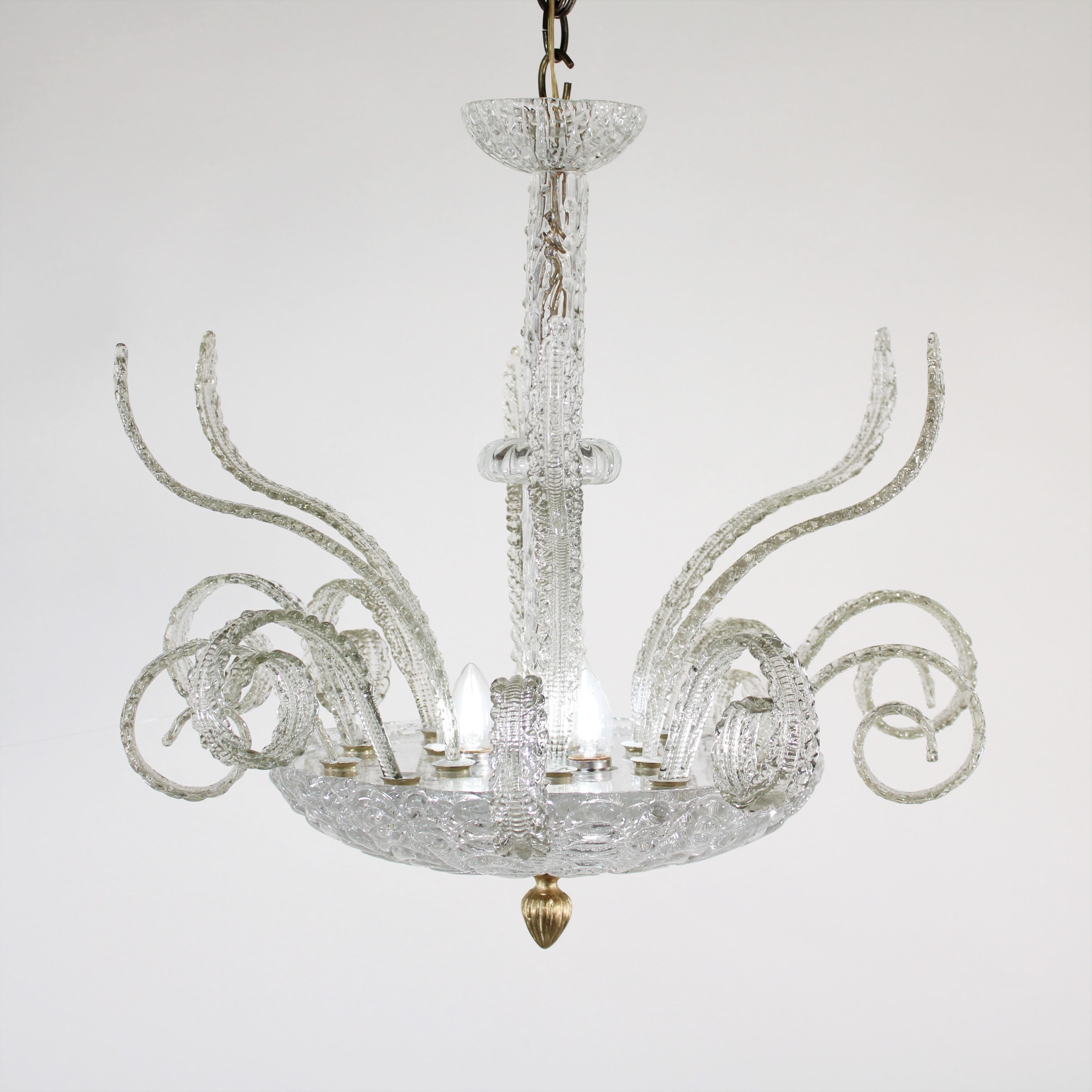Prized for their elegance, along with the intricacy of techniques and history, Murano glass chandeliers continue to add brilliance to modern and traditional homes. This Midcentury Modern clear glass chandelier that resembles a lotus flower is no