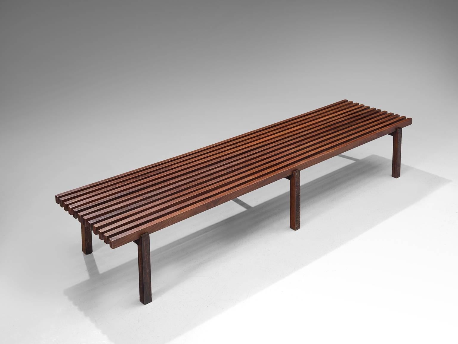 Slat bench, in stained ash and wenge wood, Europe, 1960s. 

Slat bench in stained ash for the seating and wenge wood for the legs. This bench has a modest design. The slats on top are colored dark which create a nice balance between the different