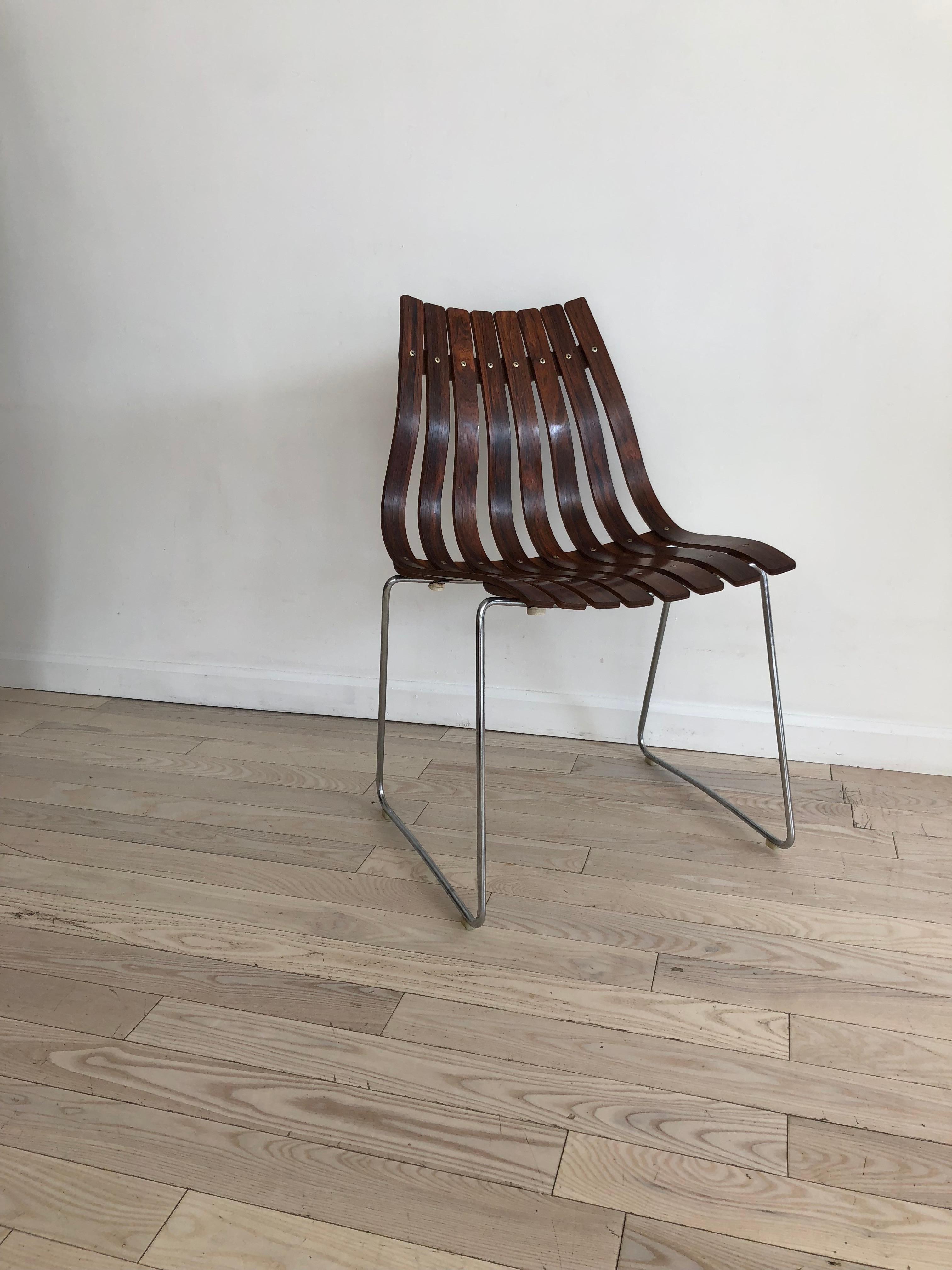 Beautiful slatted bent rosewood chair by Hans Brattrud made in Norway by Hove Mobler. From 1958. Small chip on top. Chrome legs with mild patina.
