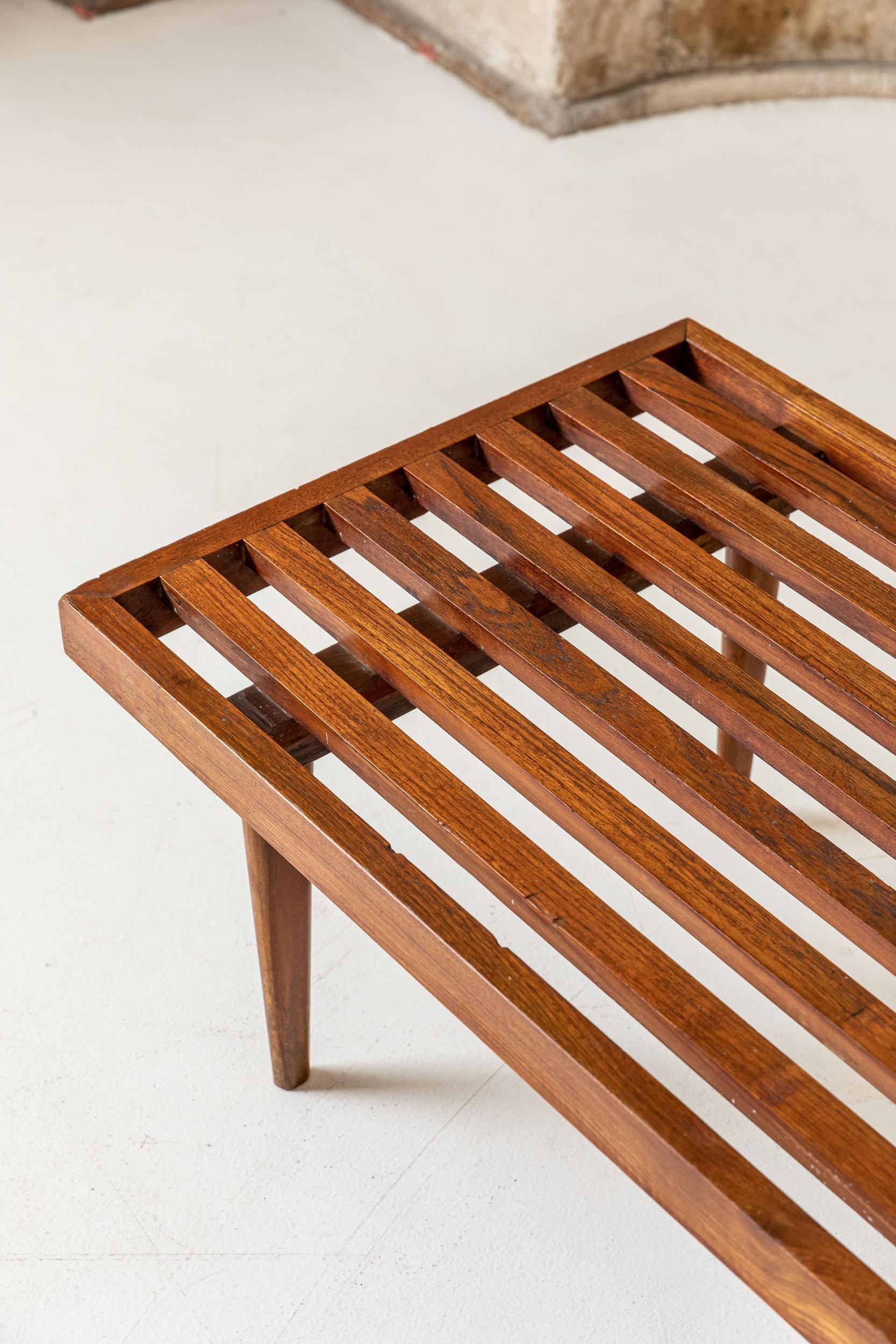 Stunning bench made of teak wood, coming from a single piece. 
Italy, 1960s.