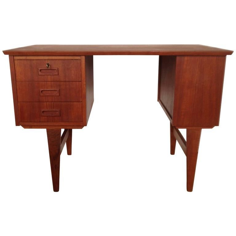 Lovely little Danish midcentury teak desk, with three drawers, one shelf on the side and one on the back.