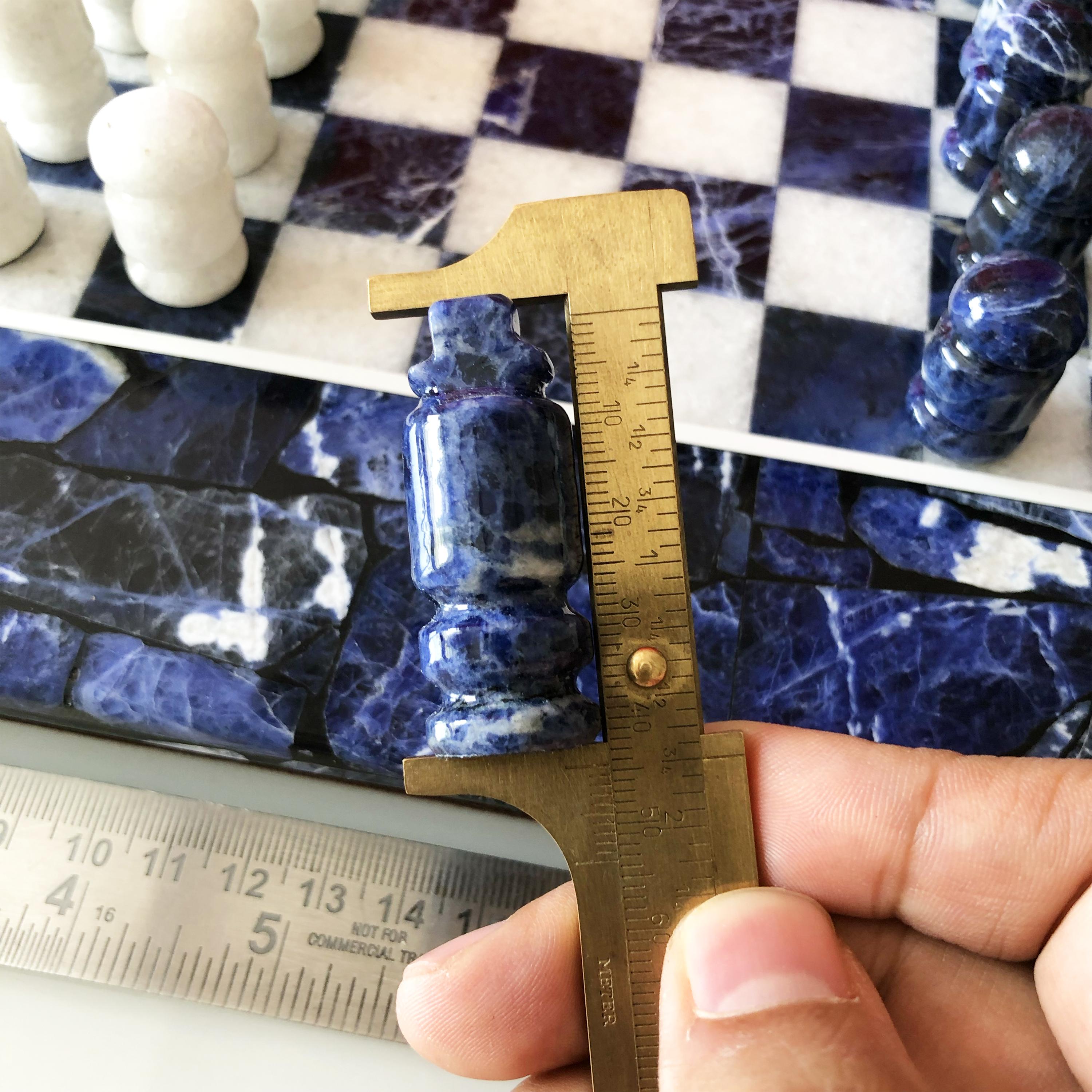 Beautiful luxurious Chess Board made of sodalite and marble. The set consists of 32 chess pieces and 1 chess board. The chess pieces are made in 2 sets - one in sodalite and other in marble. Each set of chess pieces consists of 16 pieces - eight
